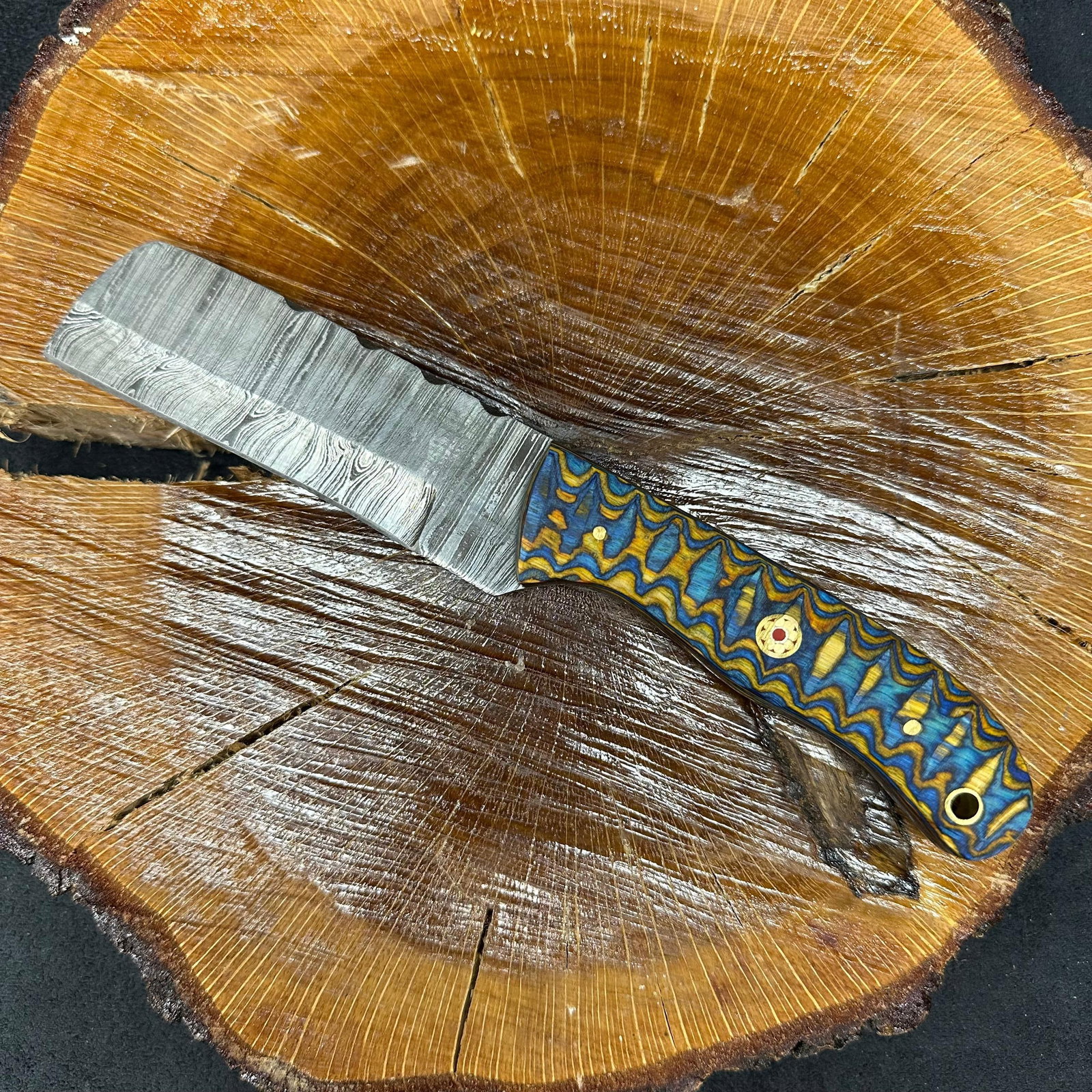 Blue Tan Colorway Design Handle MHS Cutlery Fixed Blade Knife P84 Cleaver Style: Fixed small, cleaver-style blade knife by MHS Cutlery featuring a layered patterned steel blade and decorative spine work. The handle features a contoured, wood/epoxy resin-style grip with metal 