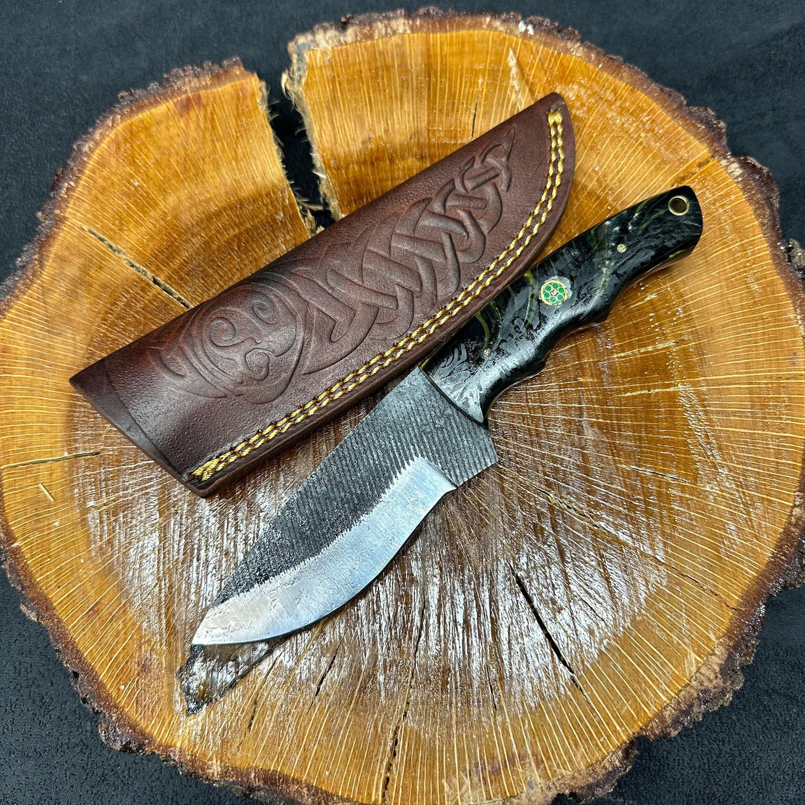 Black Colored Handle MHS Cutlery Fixed Textured Blade Knife Q15: Fixed blade knife by MHS Cutlery featuring a textured steel blade and decorative spine work. The handle has a contoured, black-colored wood/epoxy resin-style grip with metal mosaic pin accents. Includ