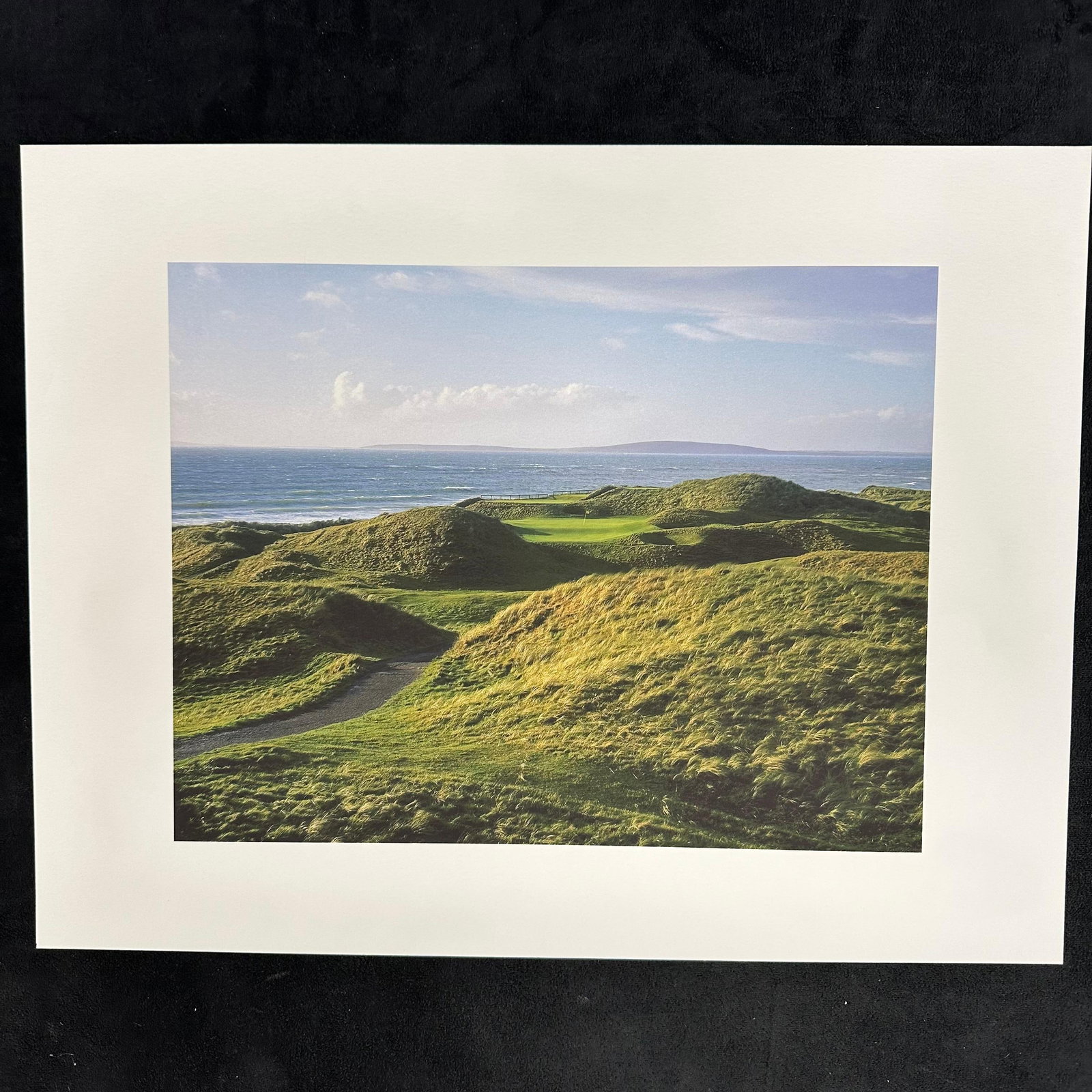 Golf Course Coastal Landscape Print Art Photography Ocean Horizon: High-quality color photographic art print depicting a scenic coastal golf course with rolling grass dunes and an ocean backdrop under clear skies. Professionally printed on thick textured paper with a