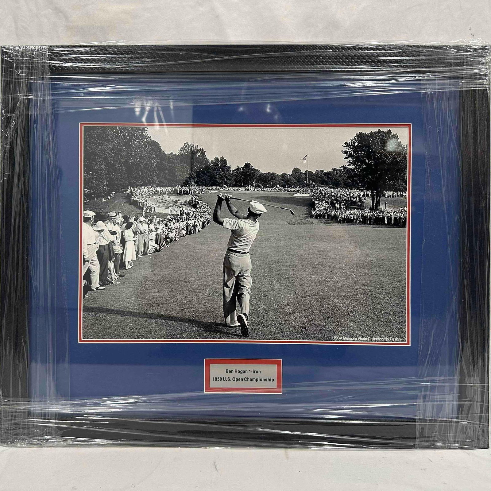 Ben Hogan 1950 U.S. Open Championship 1-Iron Shot Framed USGA Photo Collection: Framed black-and-white print of Ben Hogan’s iconic 1-iron shot at the 1950 U.S. Open, Merion Golf Club. Official USGA Museum piece, matted (with a blue and red color scheme) and framed under ple