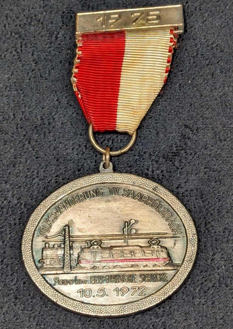 1975 Volkswanderung T.V. Saarholzbach Race Medal: 1975 Volkswanderung T.V. Saarholzbach Race Medal. This metal medal was awarded for a German 9000km race. This race took place on October 5, 1972, and is marked "G.Fisch Nalbach", this may have been th