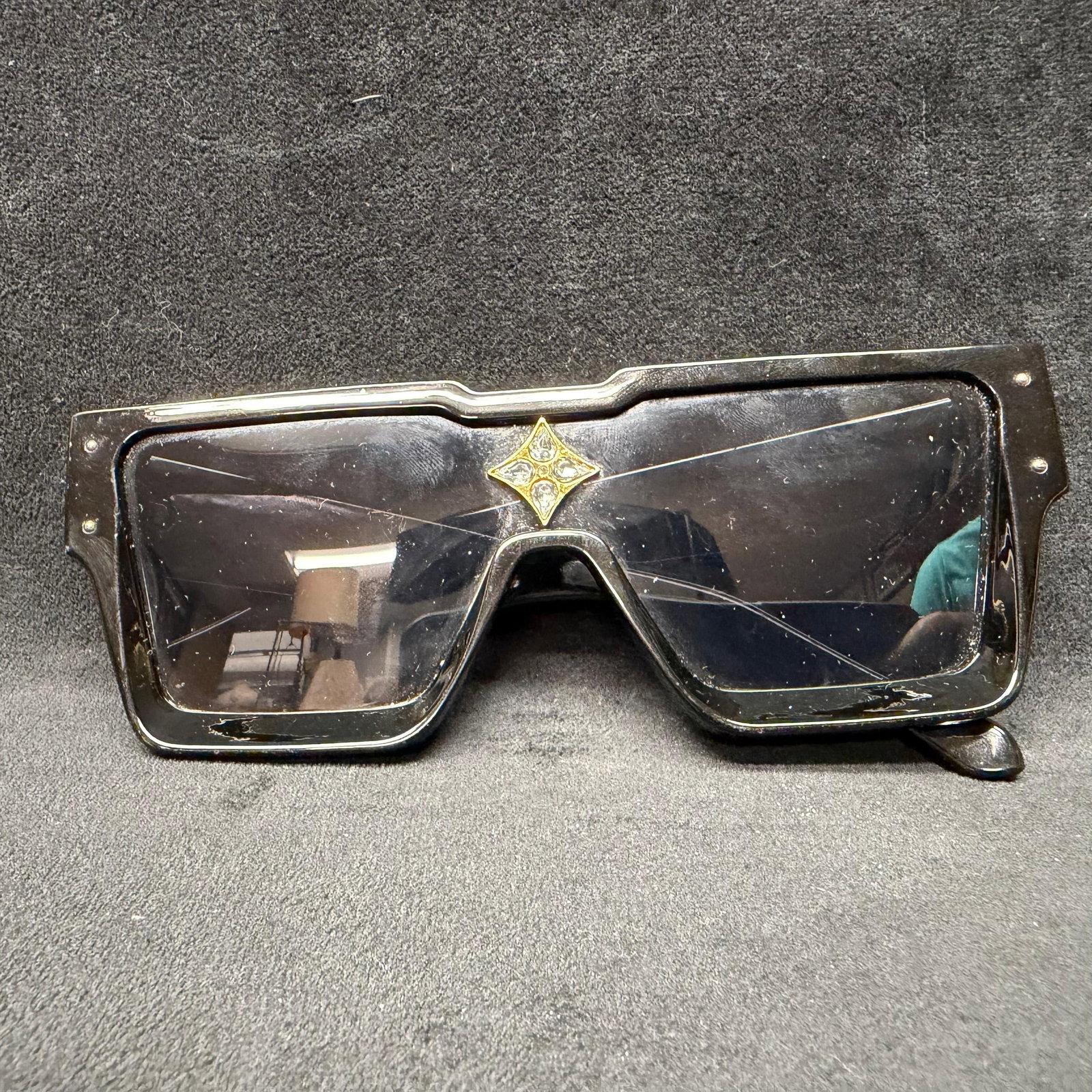 Designer Inspired Black Sunglasses LV Monogram Logo: Designer-inspired sunglasses with an LV monogram. No hallmarks or maker's marks noticed. Good pre-owned, previously displayed condition with light wear, minor scratches, and surface markings.