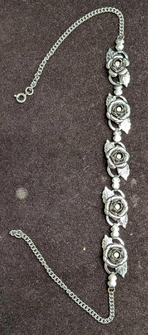 Vintage Silver Tone Rhinestone Roses Bracelet: Vintage Silver Tone Rhinestone Roses Bracelet. This is 15 1/2" and it weighs 0.06lb. The maker and date of creation is unknown. The bracelet has some light signs of wear.