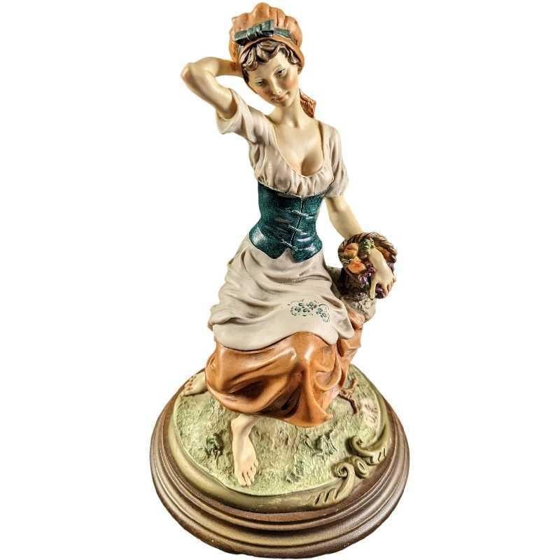 JB Giuseppe Armani Lady Figurine With Basket: Hand-painted Capodimonte porcelain of an woman in peasant dress holding a basket of flowers. The figurine is approx 7 1/2" x 7 1/2" x 12 and it weighs 5lbs. The figurine is in a good, vintage con