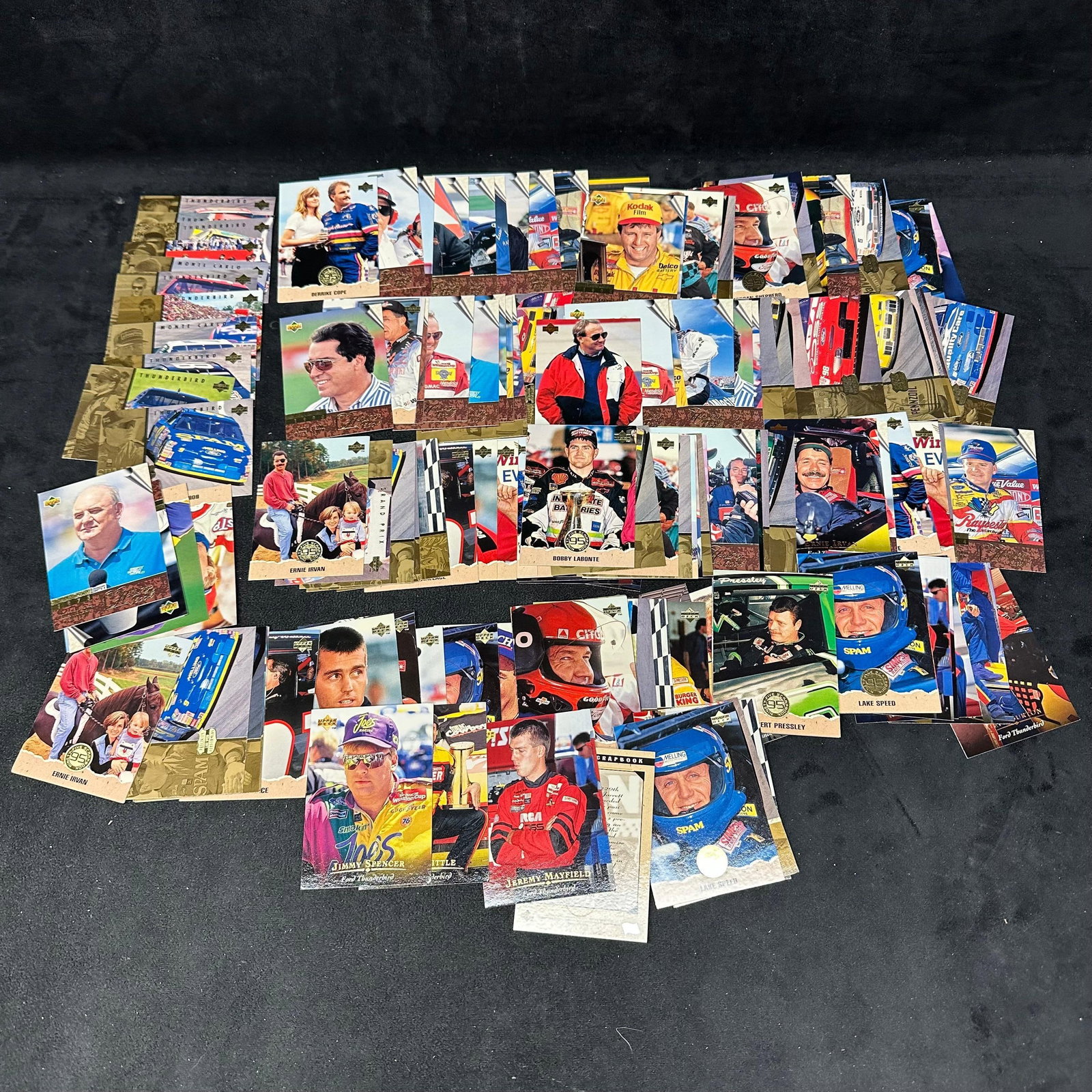 Group of 1990s Upper Deck NASCAR Racing Trading Cards: Large group of 1990s Upper Deck NASCAR racing trading cards, including driver portraits, race cars, and insert-style cards from sets such as Grand Prix, The History Book, and Precision