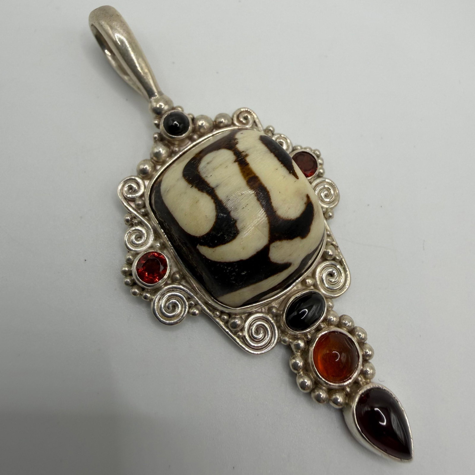 Sajen 925 Sterling Dzi Bead Amber Garnet and Black Onyx Silver Pendant: This item is in pre-owned, previously used/displayed condition with noticeable light wear and surface scratches. Please reference all photos for full details. This piece of jewelry has been tested and
