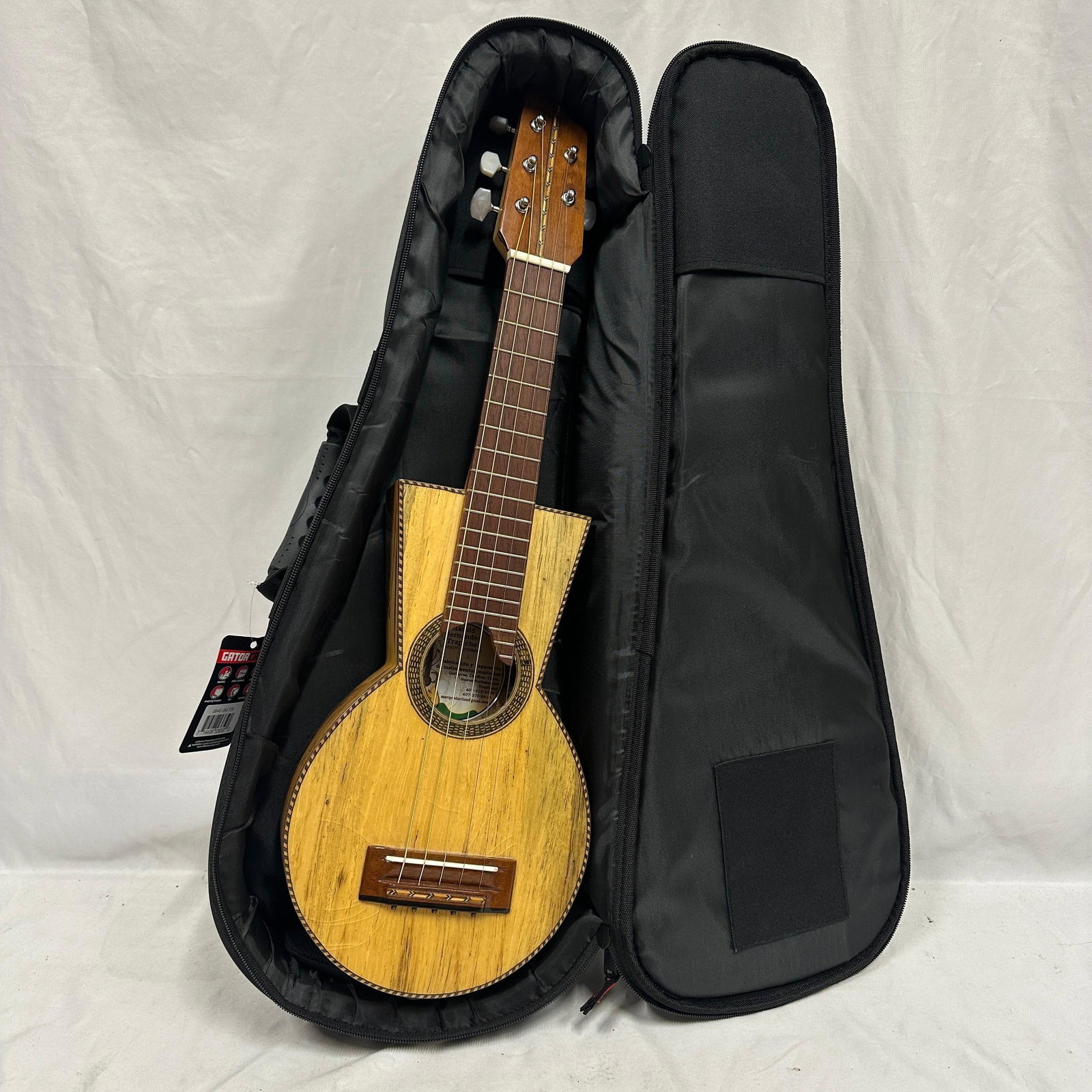 Harold Hernandez Trapiche Handmade Cuatro Tiple Style String Instrument: Handmade cuatro-style tiple string instrument by Harold Hernandez Trapiche, labeled Maestro Artesano. Features figured natural wood construction with decorative binding and a six-string