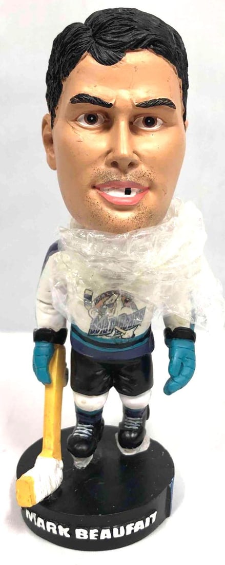 Bobble Head Of Solar Bear Hockey Player Mark Beaufait: This lot contains a bobble head of Solar Bear hockey player Mark Beaufait. The box is approx. 3 1/2" x 3 3/4" x 8" while the bobble head is approx 2 1/4" x 2 1/4" x 6 3/4". Together the box and bobble