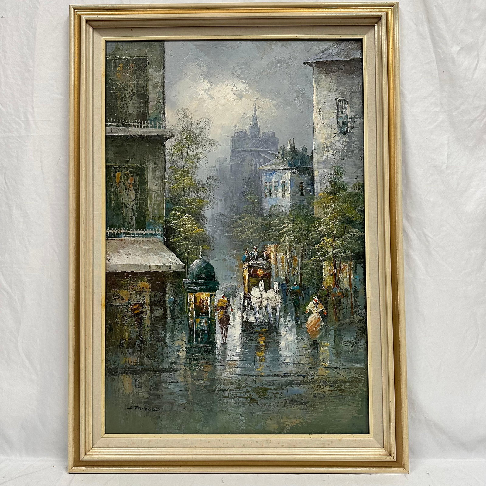 Rainy City Street Scene with Horse Drawn Carriage Signed Stanford Framed Oil Painting: A vintage oil on canvas depicting a rainy city street scene with pedestrians, a horse-drawn carriage, and atmospheric buildings fading into the mist. Executed in a textured impasto, thick style with m