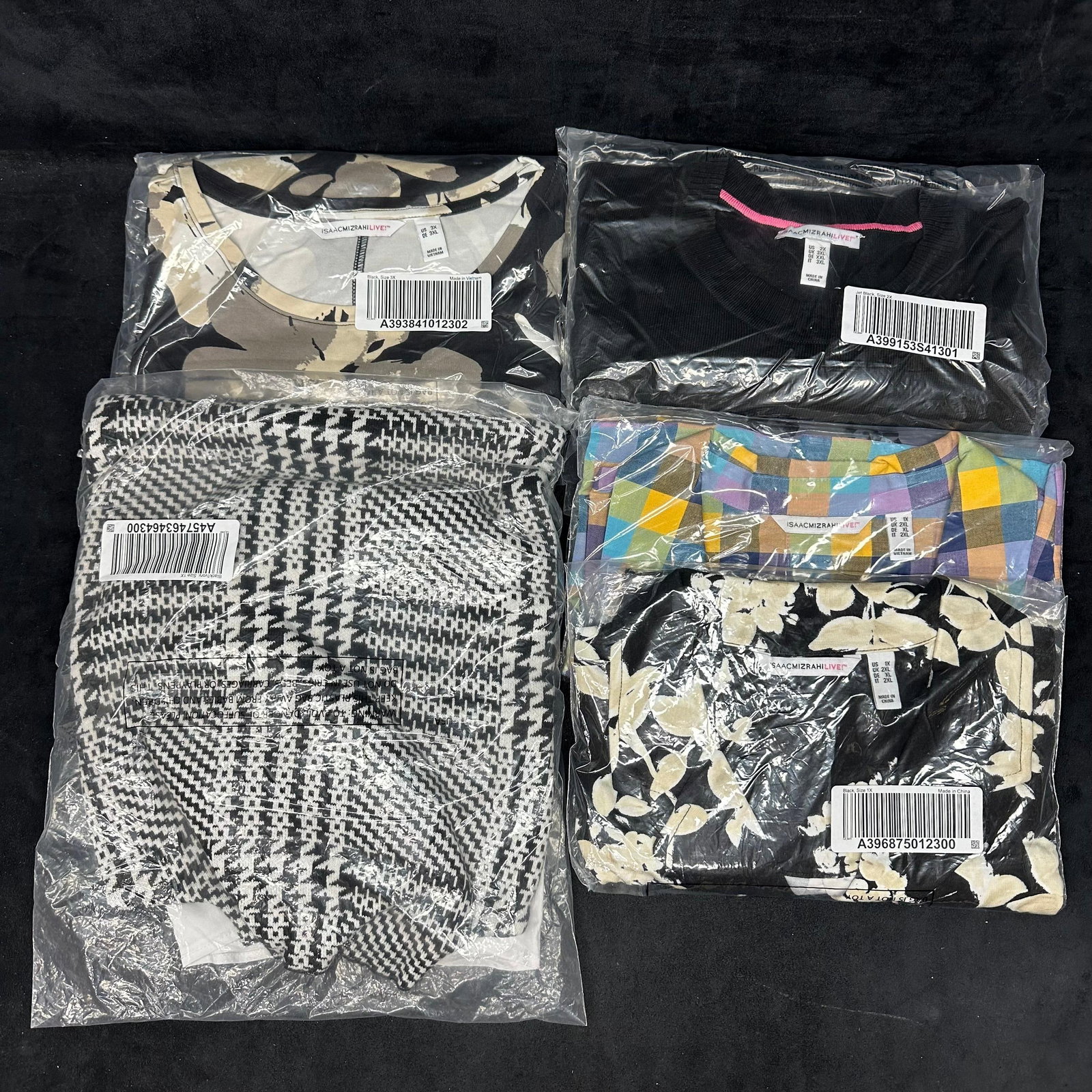 Isaac Mizrahi Live Five Tops Women Clothing Lot Q12: Group of women's Isaac Mizrahi Live! tops all sizes 1X, 2X, and 3X—mixed colors and styles. These items are in like-new, previously stored condition with wear and surface markings on the out
