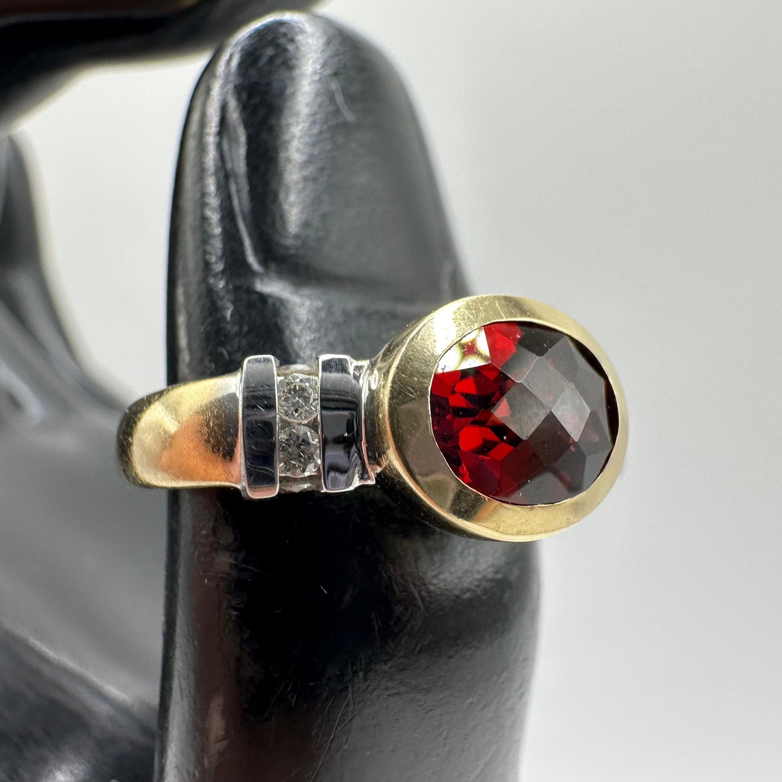 Faceted Red Garnet Accent Diamond 14K Yellow Gold Ring: This item is in good pre-owned, previously used/displayed condition with noticeable light wear and surface scratches. Please reference all photos for full details. This piece of jewelry has been teste