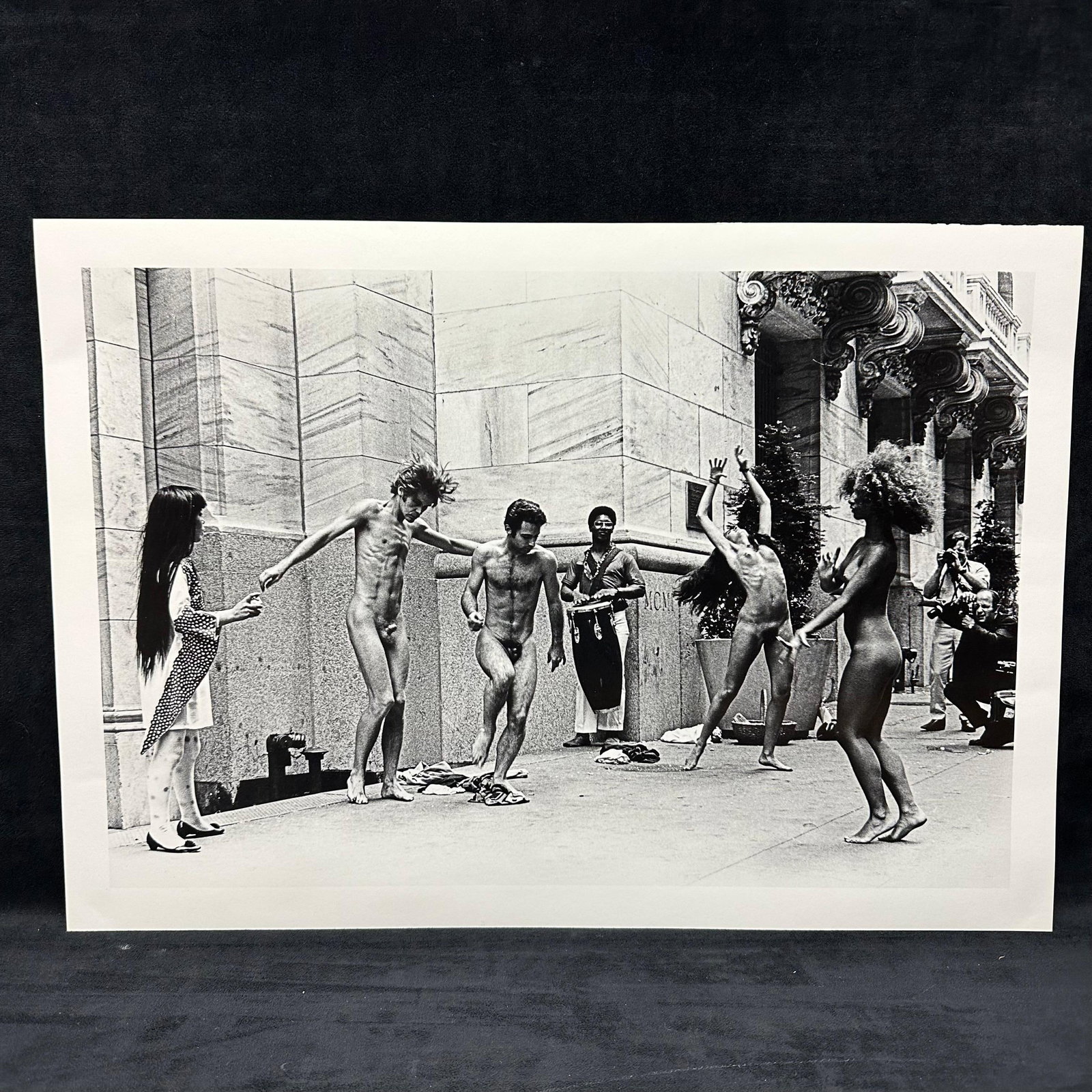 Yayoi Kusama Body Festival Black and White Large Photo Print: Large Black and white photographic print depicting Yayoi Kusama’s nude performance happening (Body Festival) outside a New York City building, circa late 1960s. The image shows dancers and