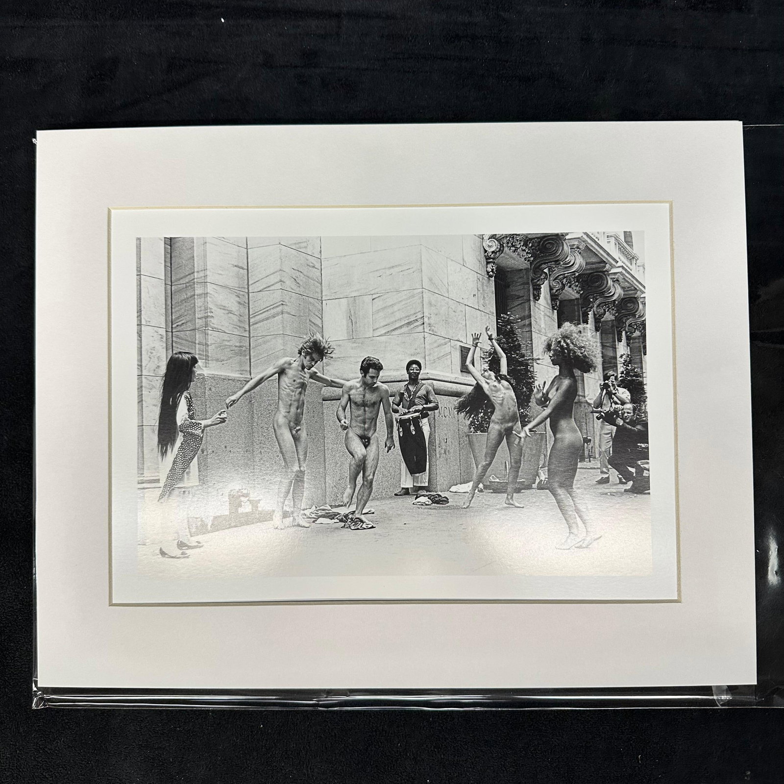 Yayoi Kusama Body Festival Black and White Photo Print Matted: Black and white photographic print depicting Yayoi Kusama’s nude performance happening (Body Festival) outside a New York City building, circa late 1960s. The image shows dancers and onlookers d