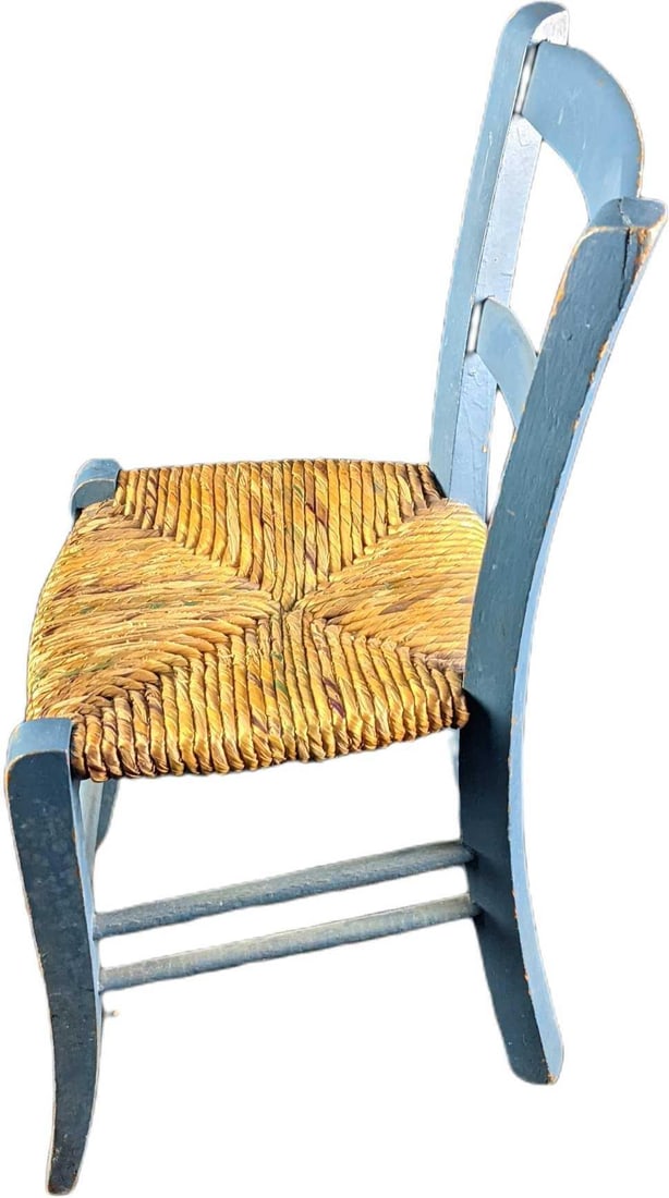 Childs Vintage Wooden And Wicker Chair: This lot contains a Childs Vintage Wooden And Wicker Chair The chair is hand painted blue with a wicker seat. It is approx 10 1/2" x 12" x 18 1/2" and it weighs 1.5lb. The chair is in a good