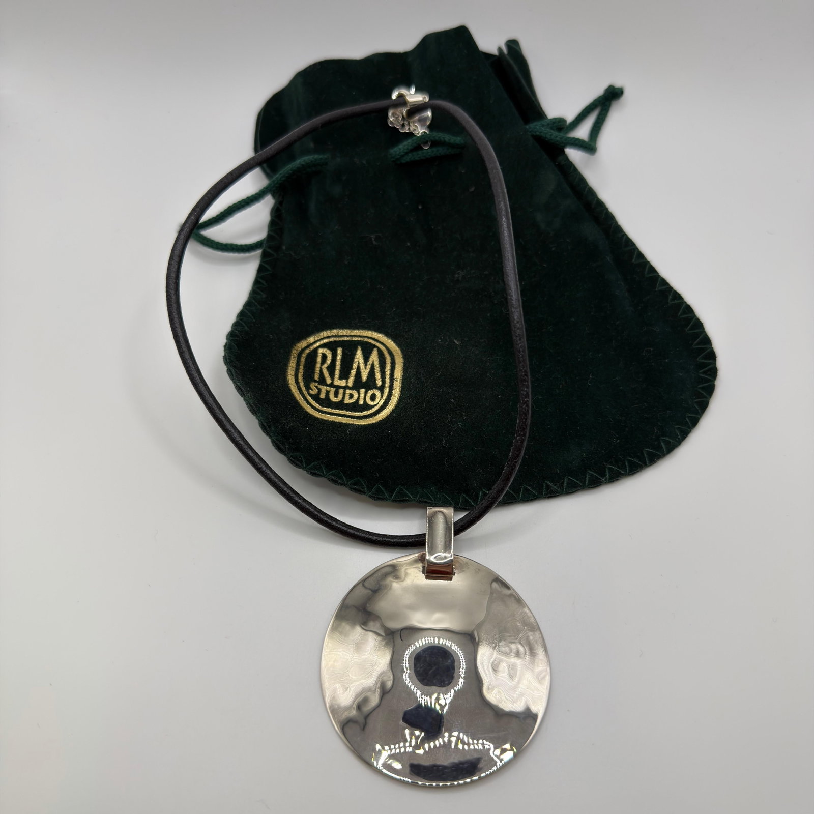 RLM Studio One World Hammered Sterling Disk Blk Leather Cord Necklace: This item is in good pre-owned, previously used/displayed condition with noticeable light wear and surface scratches. Please reference all photos for full details. This piece of jewelry has been caref