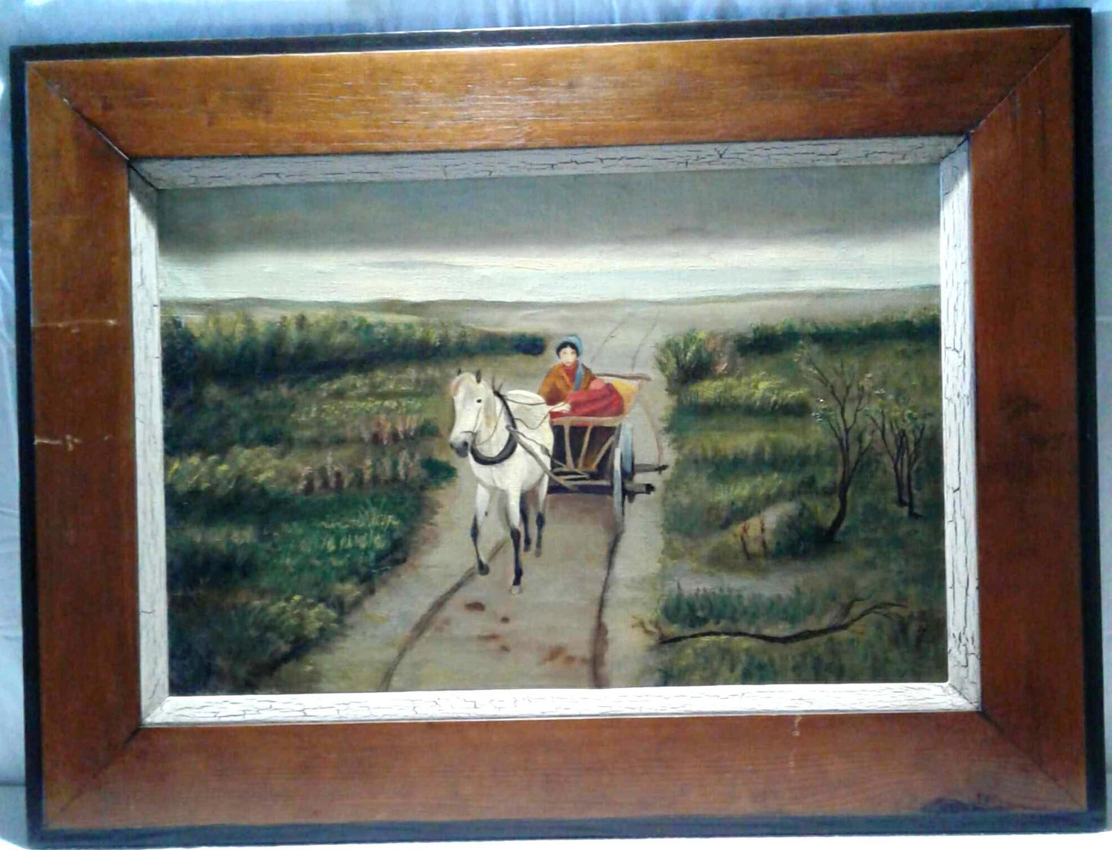 Horse Drawn Wagon with Women Painting: An original oil painting by unknown artist. Old West style frame, with a couple of scratches. The painting has a couple of age related issues, but is in good condition. It measures