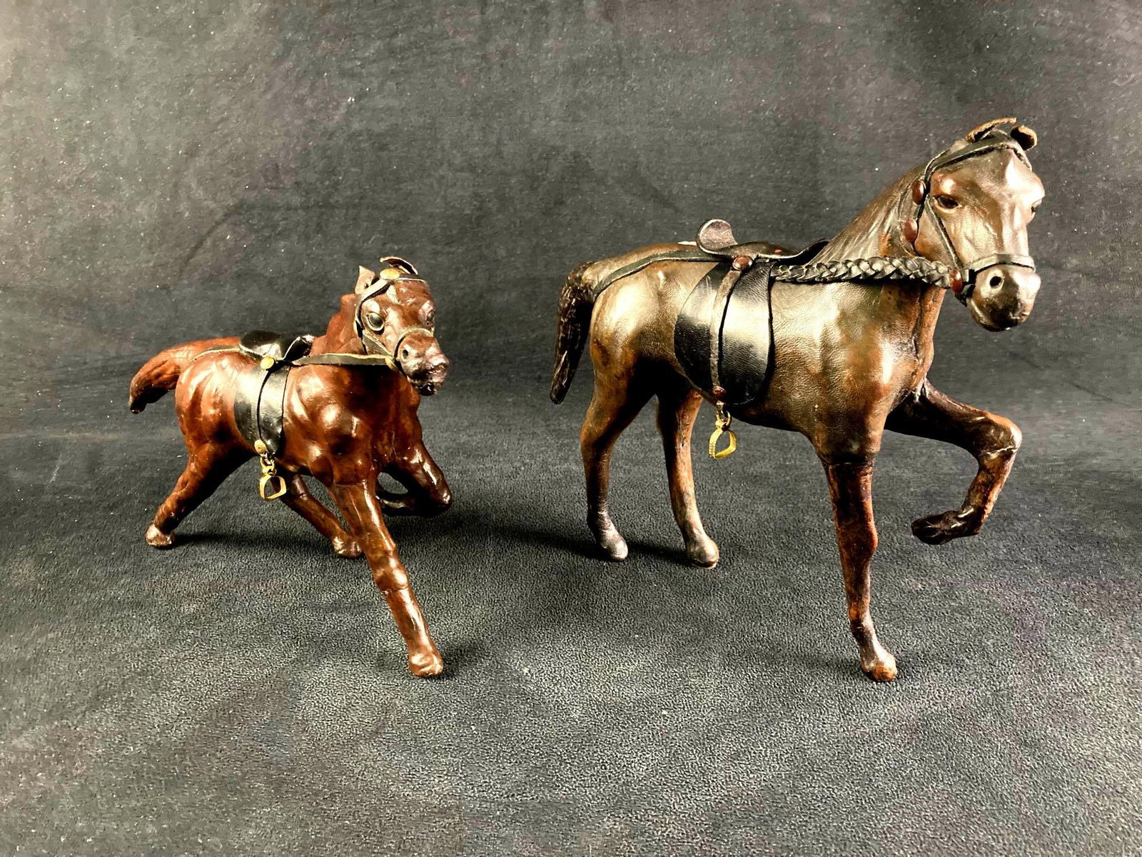 Set of (2) Leather Wrapped Horses Lot #2: Up for auction is a recent estate find, a set of (2) leather wrapped horses made in India. They are nicely made and very unique. Both have intricate details such as ears and saddles. This auction