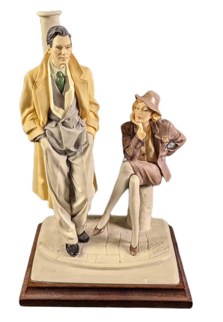 Vintage Vittorio Tessaro Romantic Moments Man & Woman: Vintage Vittorio Tessaro Romantic Moments. Made of a polystone. Shows a man and women dressed in classic dress as they wait for a taxi. Is signed by the artist on the right. Made in Italy. Is approx