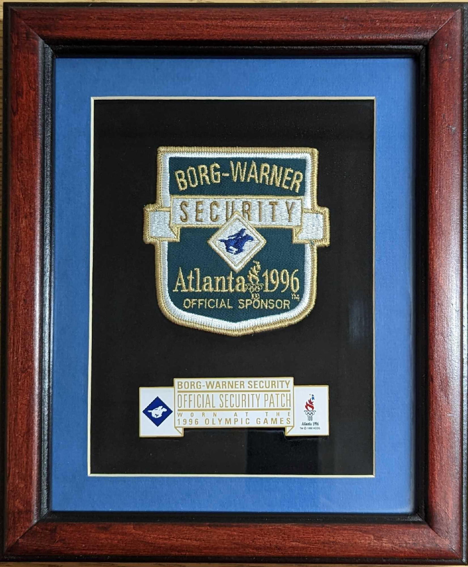 Framed Olympics Games Borg Warner Security Patch: Framed Olympics Games Borg Warner Security Patch. This is approx 9 3/4" x 1" x 11 1/2" and it weighs 1.53lb. The frame has some markings and there are some smudges on the plex. Please see the images