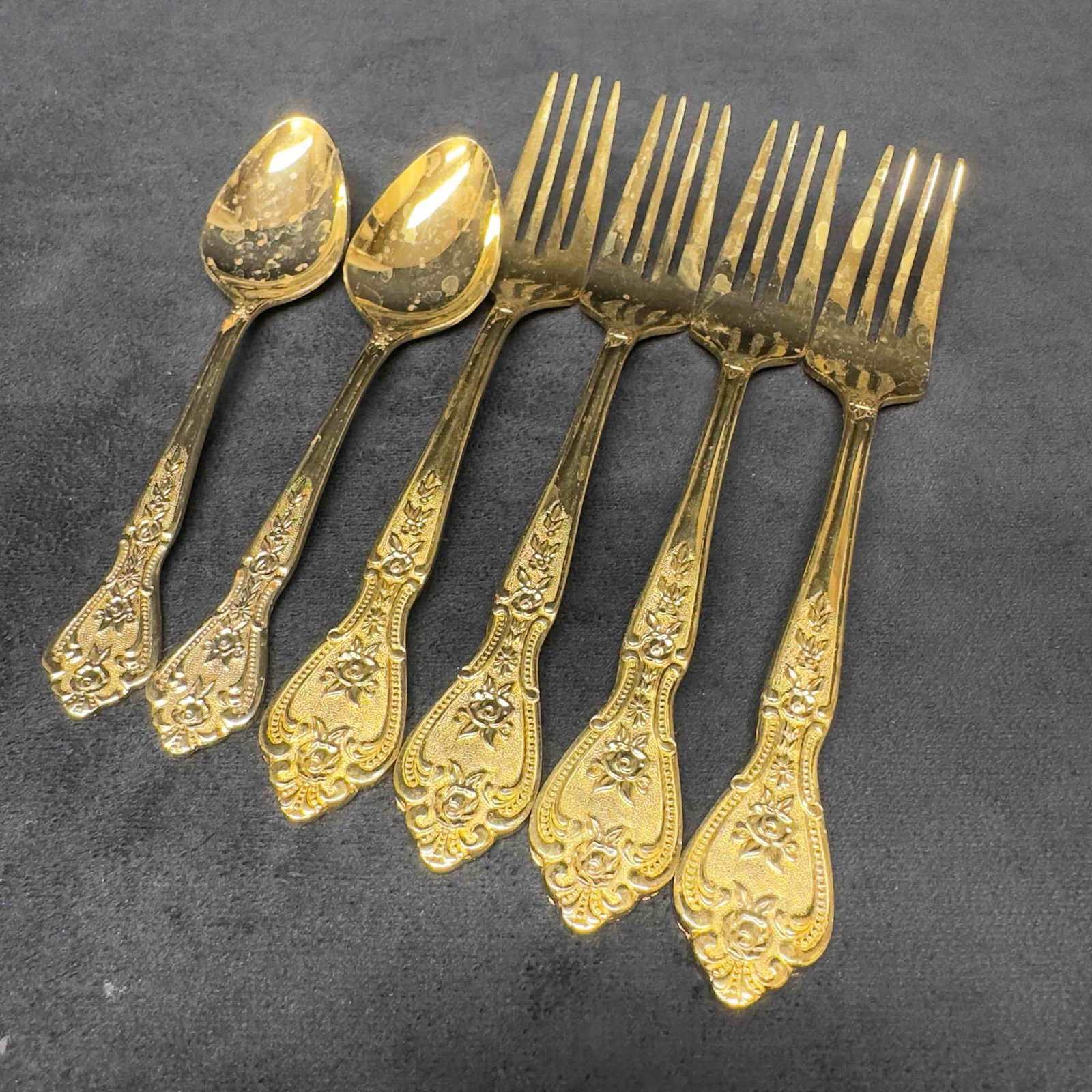 Rogers Gold Tone Stainless Floral Royalty Design Set Forks and Spoons: Rogers Gold Plated Stainless Gold Royalty Set Forks and Spoons. This silverware set includes 6 pieces of flatware. Each handle features a Gold Royalty floral design. Silverware pieces included
