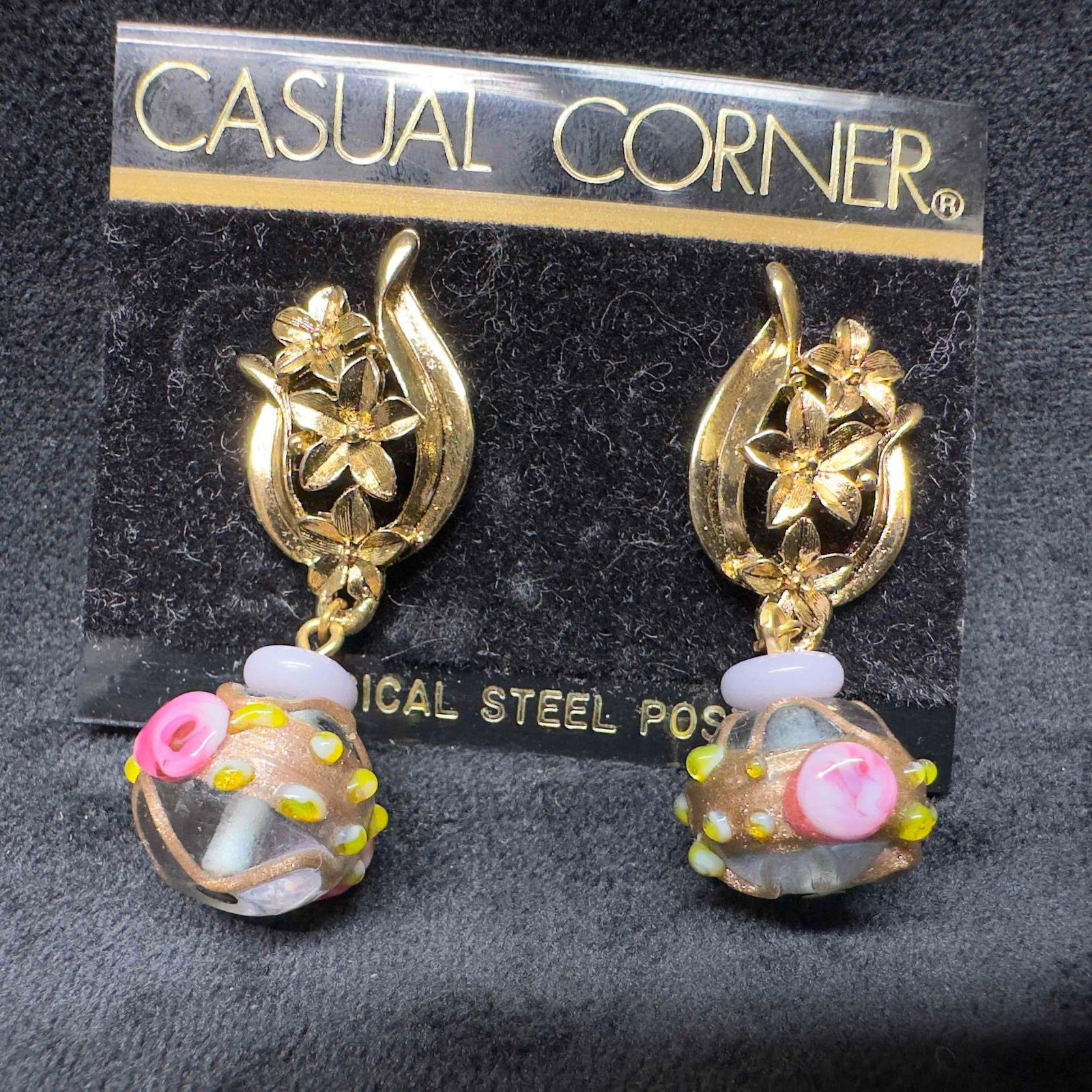 Murano Venetian Art Glass Lamp Work Floral Purple Bead Dangle Drop Flower Clasp Earrings H21: Murano Venetian Art Glass Lamp Work Floral Purple Bead Dangle Drop Flower Clasp Earrings H21. Earrings with purple colored glass beads with beautiful designs on each. The earrings feature copper color