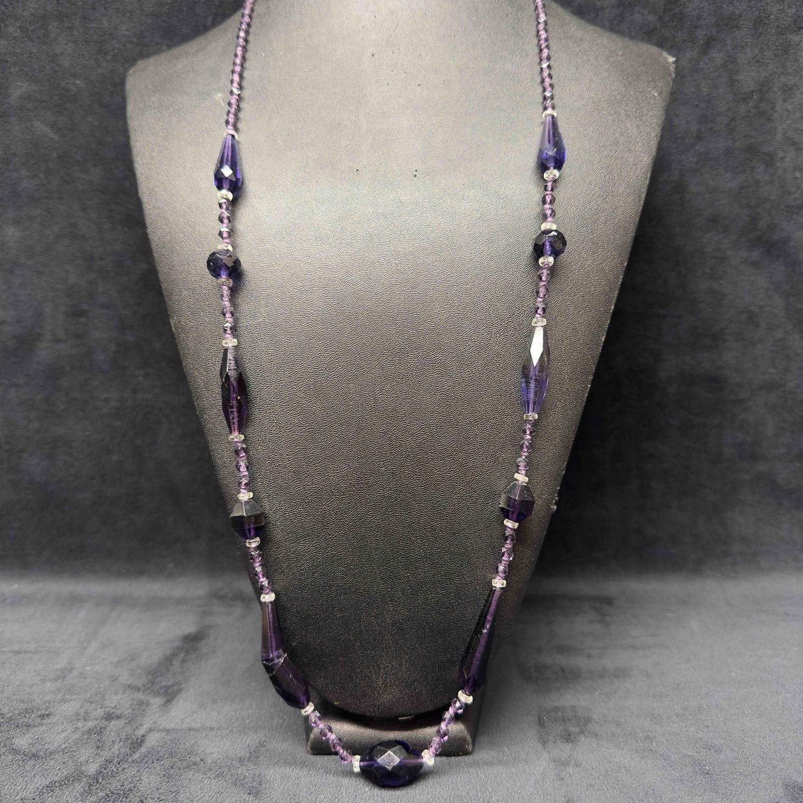 Purple Glass Crystal Beaded Costume Jewelry Long Necklace H71: Purple Glass Crystal Beaded Costume Jewelry Long Necklace H71. Necklace with purple glass beads with beautiful designs. The necklace has one bead that is broken. Minor imperfection with one glass bead