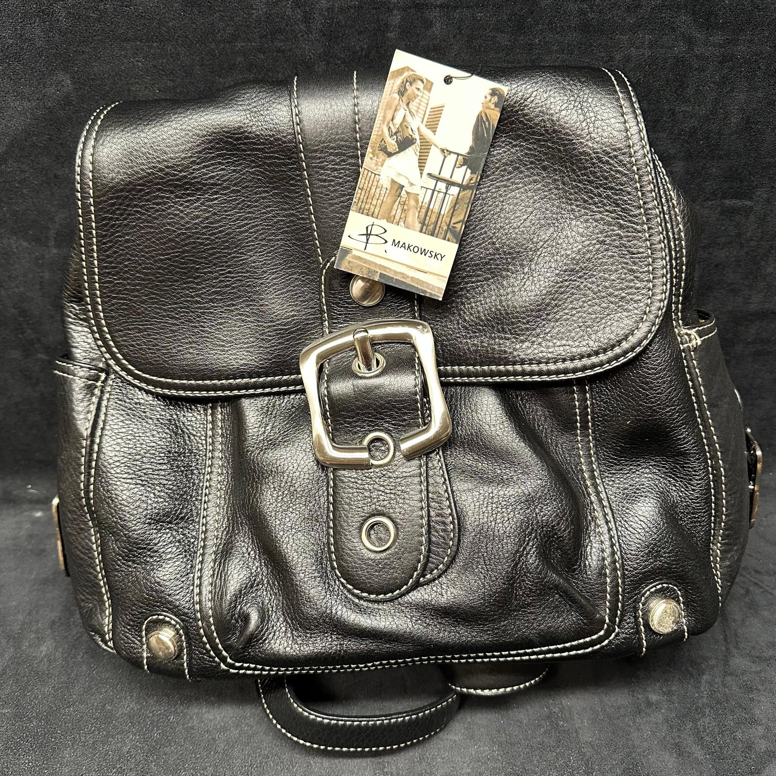 Tribeca Black Backpack B Makowsky Genuine Leather Bag: Includes a black dust bag. Shows light wear consistent with normal use. This item is in like-new, previously stored condition with light wear and surface scratches. Original tag still intact. Ple