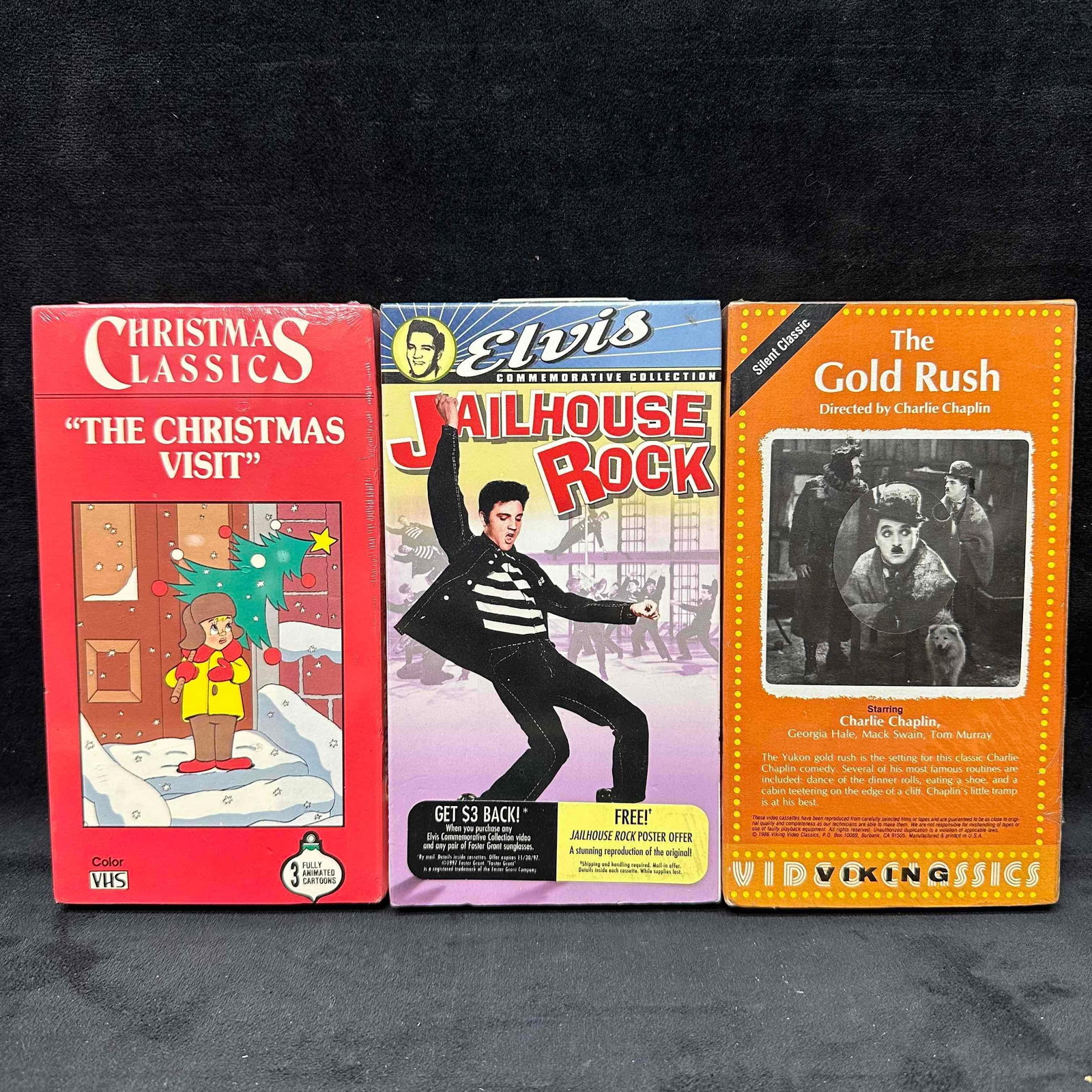 Lot of 3 VHS Movies The Christmas Visit Elvis Jailhouse Rock The Gold Rush Sealed: Collection of 3 VHS movies including "The Christmas Visit" (Christmas Classics, sealed), "Jailhouse Rock" (Elvis Commemorative Collection, MGM/UA, includes poster offer, sealed), and &