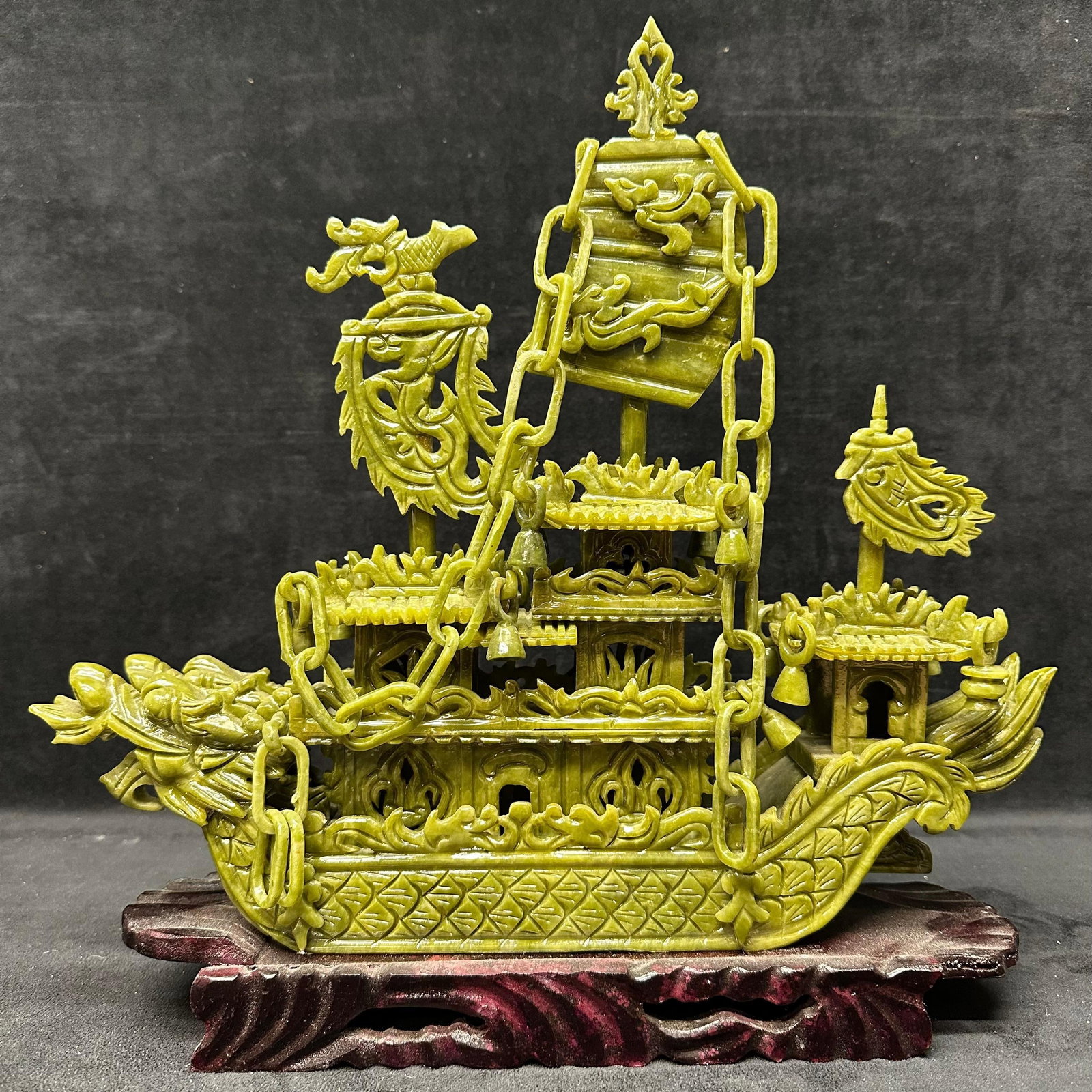Faux Jade Fine Carved Resin Green Dragon Boat Ship Decorative Figure Wood Base: Intricately carved green resin faux stone Chinese-style dragon ship featuring pagoda-style structures, hanging chains, dragon heads, and ornamental sails. The piece includes a separate carved wood dis