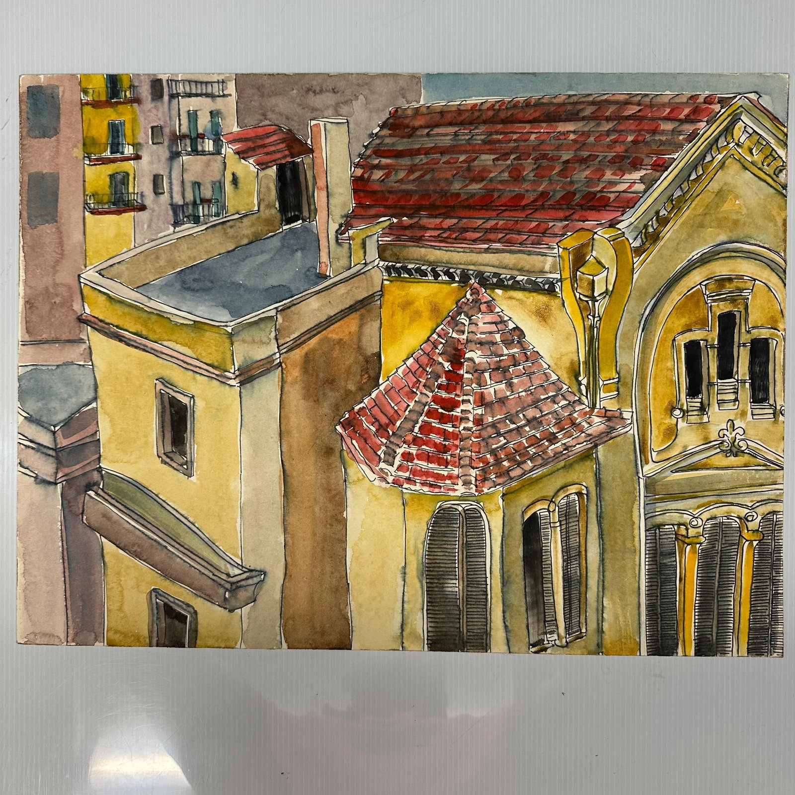 Original Watercolor Architectural Cityscape with Tile Roof Buildings: Original watercolor painting on paper depicting an architectural cityscape with Mediterranean-style buildings, red tile roofs, balconies, and shuttered windows. Executed in a detailed,