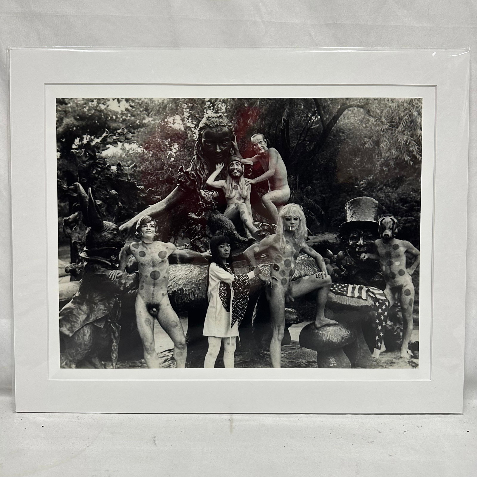 Yayoi Kusama Black and White Photo Print Central Park NY Nude Matte: Medium Black and white photographic print depicting Yayoi Kusama posed with polka-dotted nude models in an outdoor sculptural statue, Alice in Wonderland, setting in New York's Central Park.