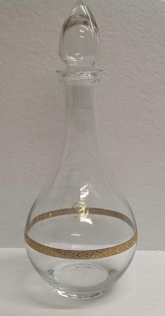 Pasabahce Gold-Rimmed Glass Decanter With Stopper: Pasabahce Gold-Rimmed Glass Decanter With Stopper. Made in Turkey. This is approx 5" x 5" x 23 3/4" and it weighs 1.21lb. The decanter has no chips or cracks.
