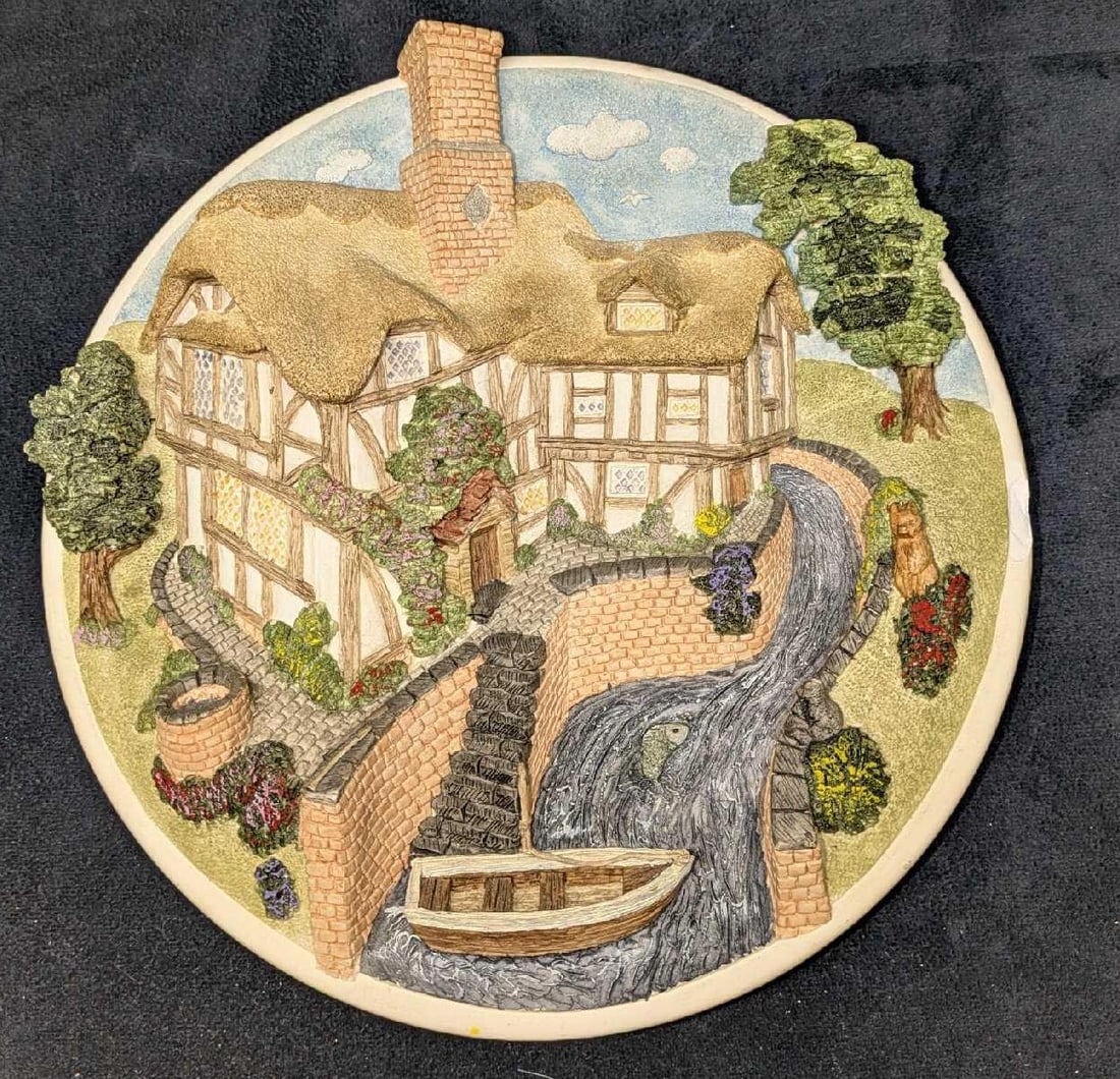 Vintage David Winter Cottages On The Riverbank Plate: Vintage David Winter Cottages On The Riverbank Plate. This collector plate is approx 9" x 3 /4" x 9" and it weighs 2.82lbs. The plate has some markings and a chip on the right side.It comes with a sta