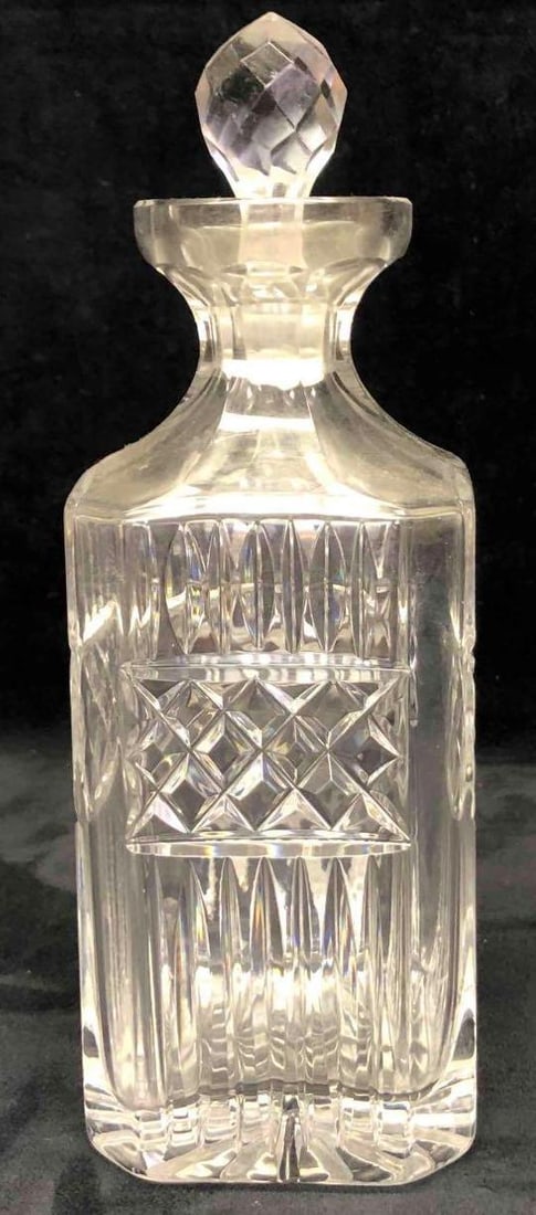 Crystal Liquor Decanter: This lot contains a crystal liquor decanter. This crystal decanter is the perfect decoration for any bar or liquor cart. The decanter was made by an unknown manufacturer. It is approx. 3 1/2" x 3 1/2"