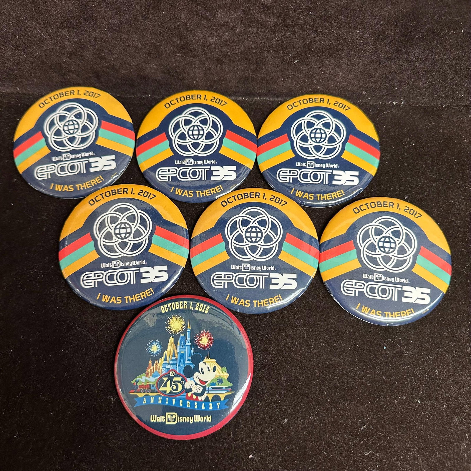 Walt Disney World Epcot and Magic Kingdom I Was There Anniversary Button Set Seven: Disney commemorative anniversary buttons from Epcot 2017 and Magic Kingdom 2016. Seven buttons included. These items are in pre-owned, previously stored condition with light wear and surface