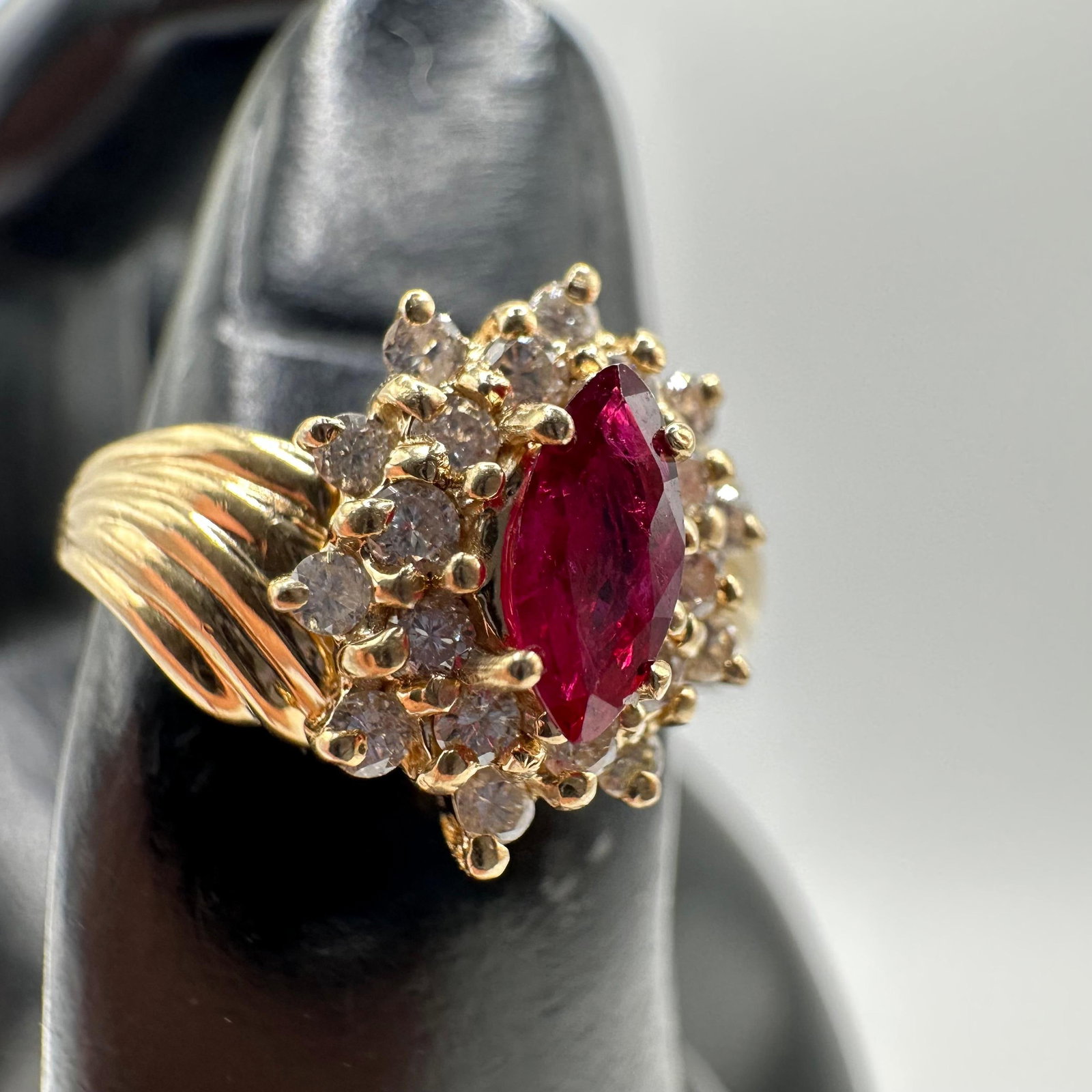 14K Gold Marquise Cut Lab Ruby and Halo Style of Accent Diamonds Ring: This item is in good pre-owned, previously used/displayed condition with noticeable light wear and surface scratches. Please reference all photos for full details. This piece of jewelry has been teste