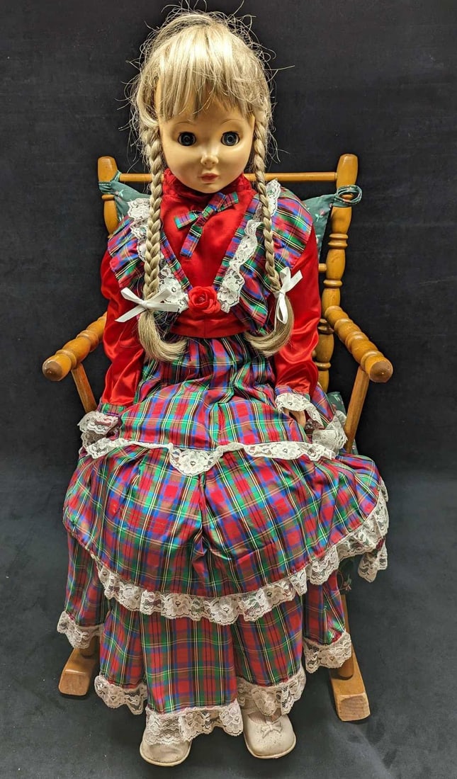 Vintage Eugene Doll Co Full Sized Girl Rocking Chair Display: Vintage Eugene Doll Co Full-Sized Girl Rocking Chair Display. Here is a full-sized young girl doll by the Eugene Doll Co. She is wearing a flannel dress and her hair is braided with pigtails in the fr
