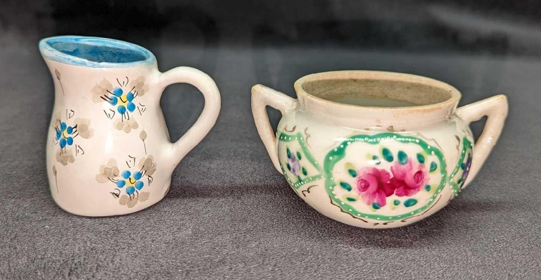 Vintage Ceramic Creamer & Sugar Bowl: Vintage Ceramic Creamer & Sugar Bowl. The creamer is approx 3" x 2 1/4" x 2 1/2". Has some crazing and a chip on the top. The sugar bowl is approx 4" x 3" x 2". This has some markings. The total