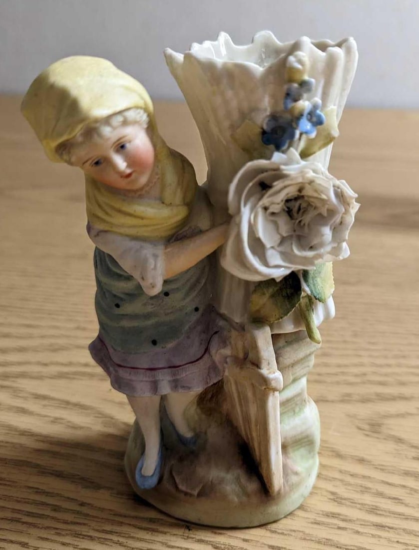 Vintage Ceramic Woman Vase: Vintage Ceramic Woman Vase. Maker and date of creation is unknown. Hand-painted. Is approx 3" x 2" x 6" and it weighs 0.67lb. The vase has a crack inside and the large and small flowers have some