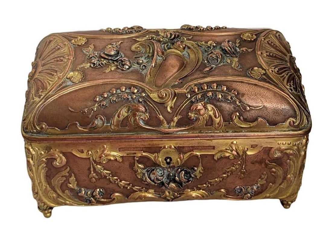 Vintage Gold Gilded Heavy Copper Coffin Trinket Box: Vintage Gold Gilded Heavy Copper Coffin Trinket Box. The maker and date of creation are unknown. Has a nice floral design and comes with key. This is approx 7" x 4" x 3 1/2" and it weighs 3.76lbs. The