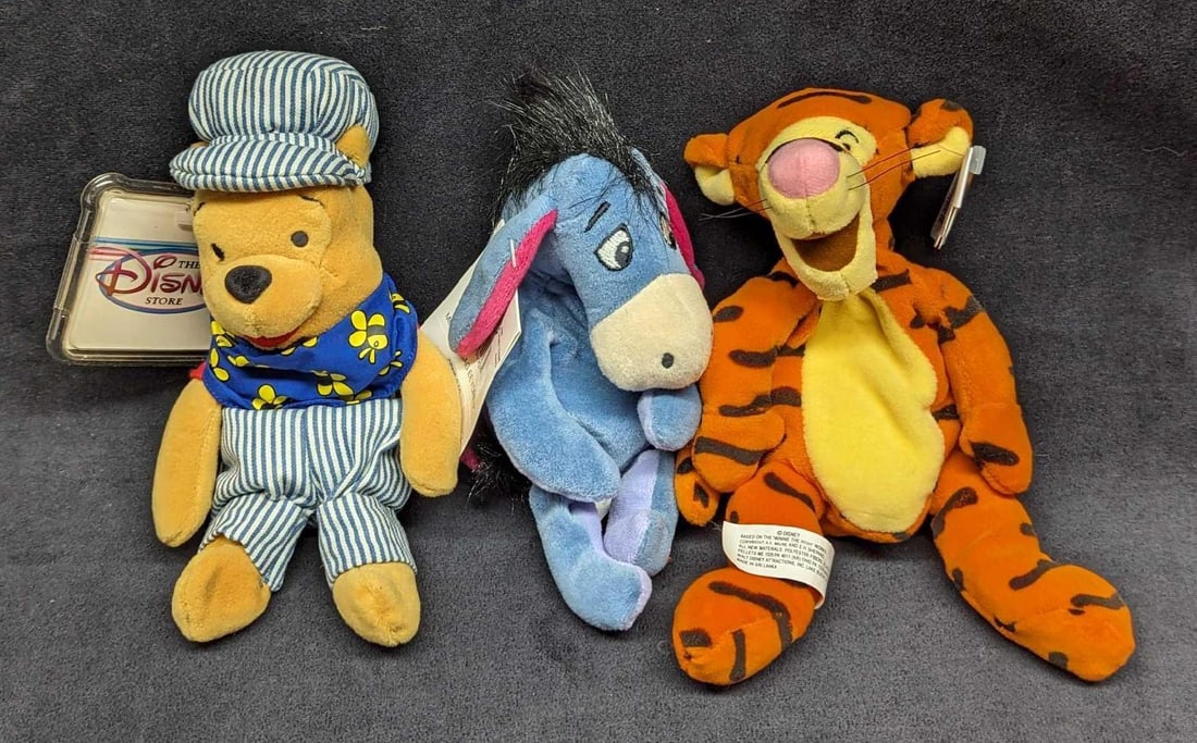 3 Disney Winnie The Pooh Bean Bag Dolls: 3 Disney Winnie The Pooh Bean Bag Dolls. This lot contains: (1) Eeyore Bean Bag Doll. This is approx 3" x 4" x 9". (1) Tigger Bean Bag Doll. This is approx 4 1/2" x 5" x 9".