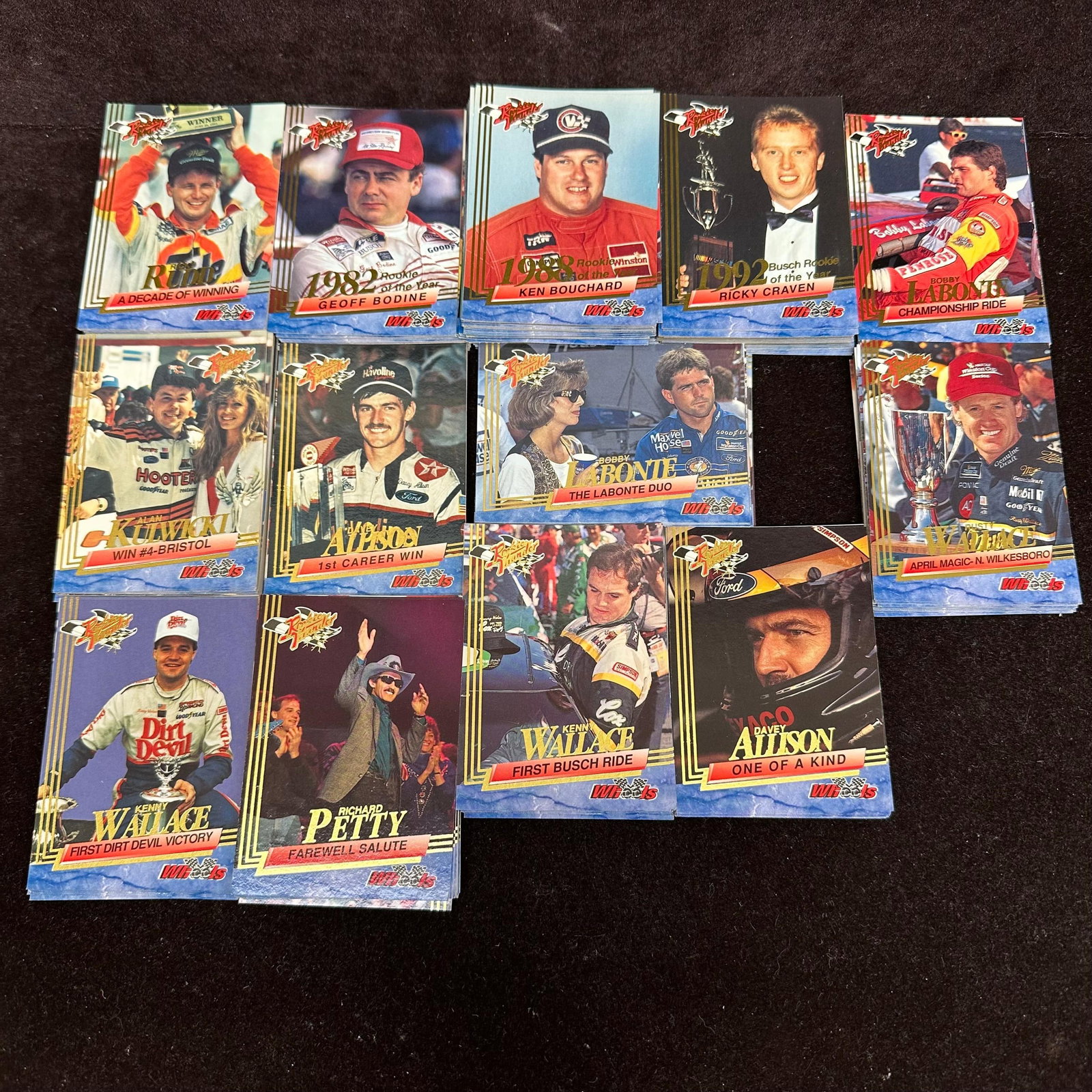 Large Lot NASCAR Rookie Thunder Trading Cards Wheels Racing: Large group of NASCAR “Racing Rookie” trading cards by Wheels Racing Inc. featuring drivers and racing highlights. 1990s Cards pictured include examples of Geoff Bodine, Ken Bouchard, Rick