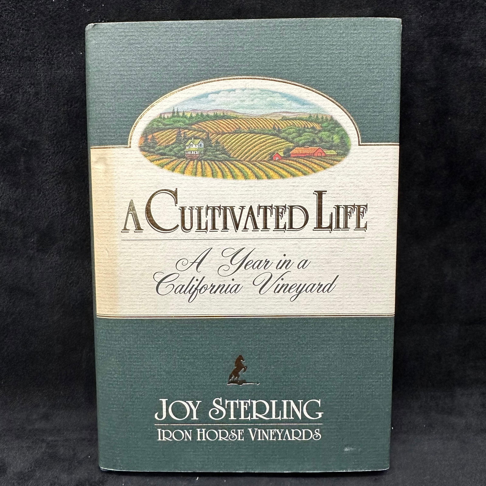 A Cultivated Life A Year in a California Vineyard Joy Sterling Signed Hardcover Book: Signed by Joy Sterling with a personal inscription to Michel Roux, includes a letter and business card. Condition shows general handling wear, scuffing, and surface marks to the cover consistent with 