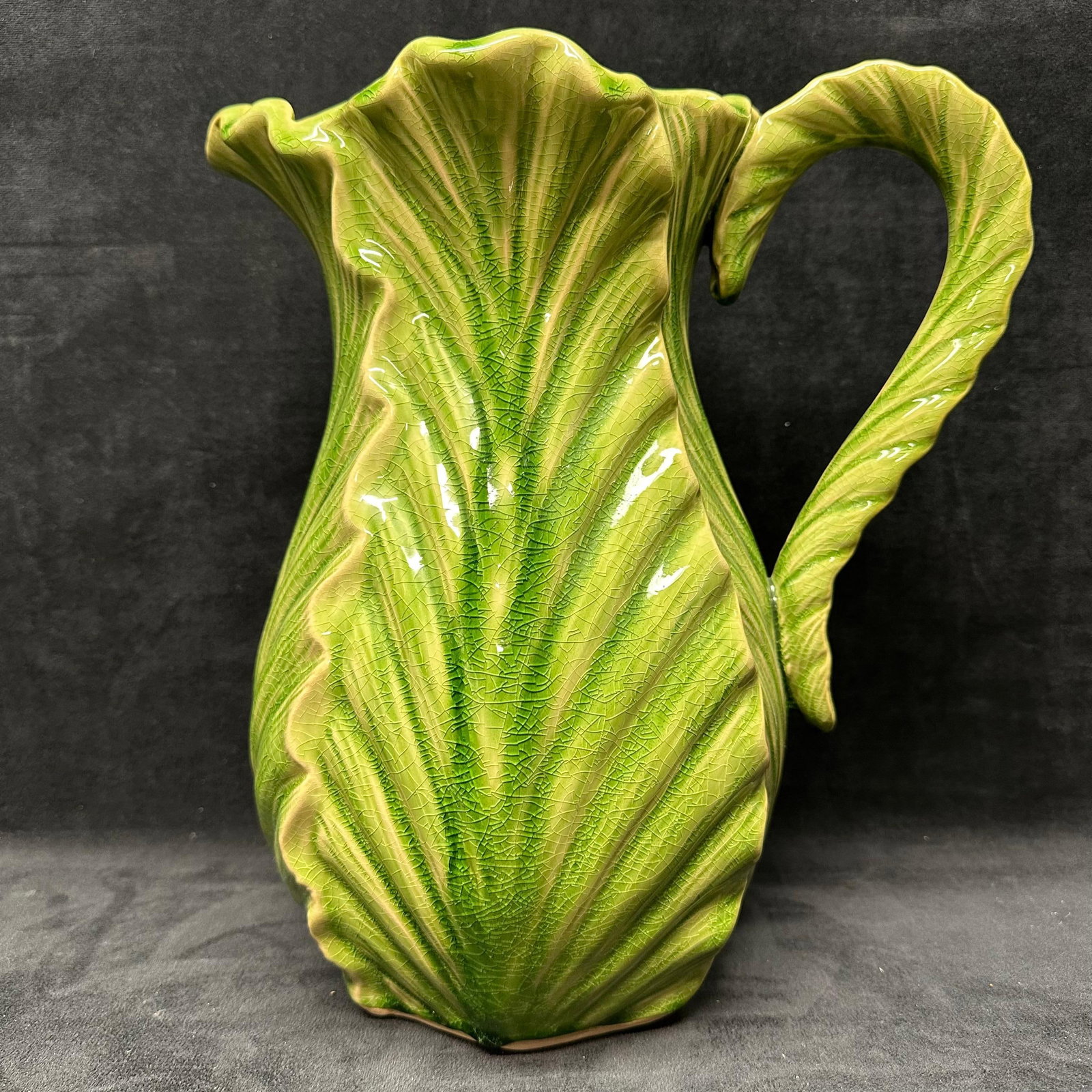 Large Green Leaf Form Cabbage Lettuce Design Majolica Style Ceramic Pitcher Leafy Greens: Large decorative ceramic pitcher molded in a leafy, botanical form. The body and handle are sculpted to resemble overlapping leaves with raised vein detailing. Finished in a glossy green glaze with na