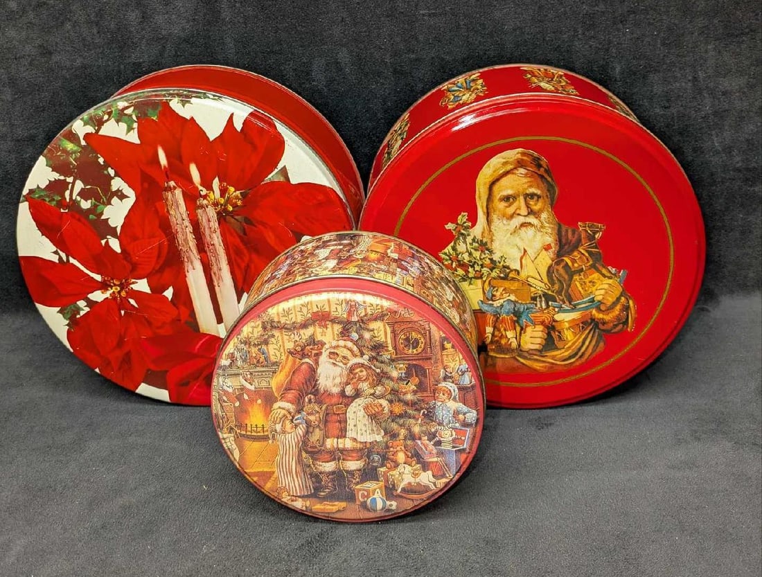3 Vintage Christmas Themed Round Tins: 3 Vintage Christmas Themed Round Tins. This lot includes: (1) Santa With Kids Tin. This is approx 5 1/2 x 5 1/2" x 2 3/4". Has light dents and scratches on the top. (1) Santa From Different Co
