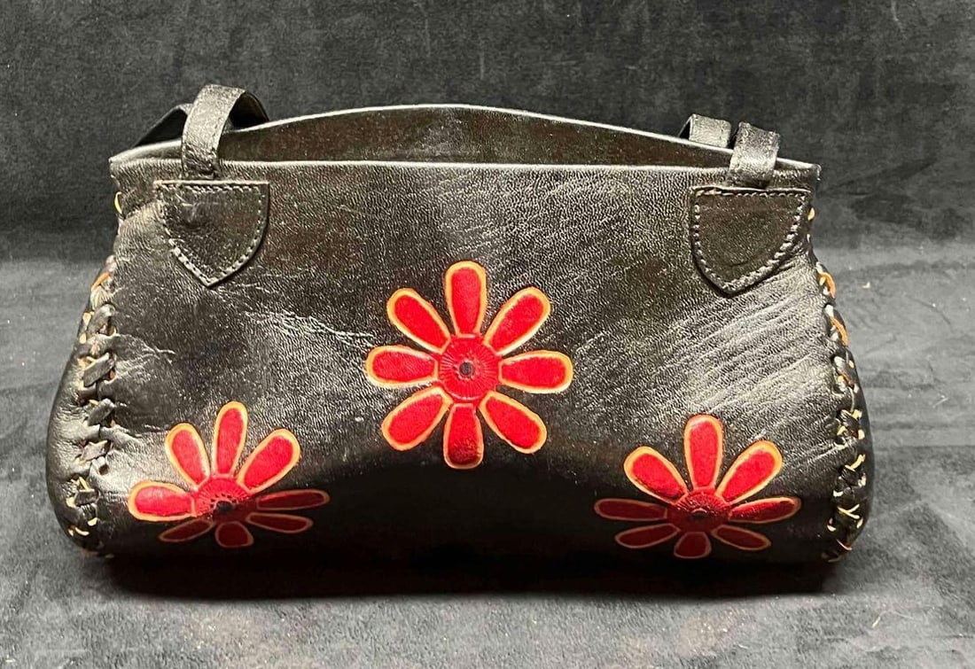 Vintage Leather Handicraft Purse With Embossed Flowers (20): This lot contains a Vintage Leather Handicraft Purse With Embossed Flowers (20). The bag is hand-stitched and has a very soft leather liner and inside zipper pocket. It is approx 10 1/2" x 2 1/2" x 7"