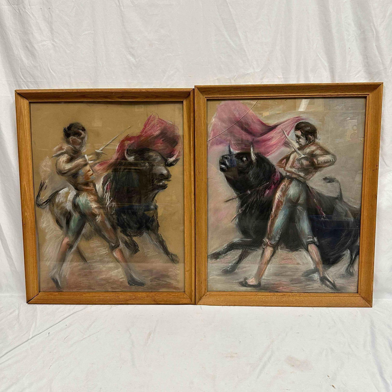Matador and Bullfighter Pastel Drawing Set Framed Artwork R152: Two oil based pastel artworks featuring bullfighting scenes. Each art piece and frame has noticeable wear, one frame is slightly cracked and loose at the bottom, the other has tape on the back, and ea