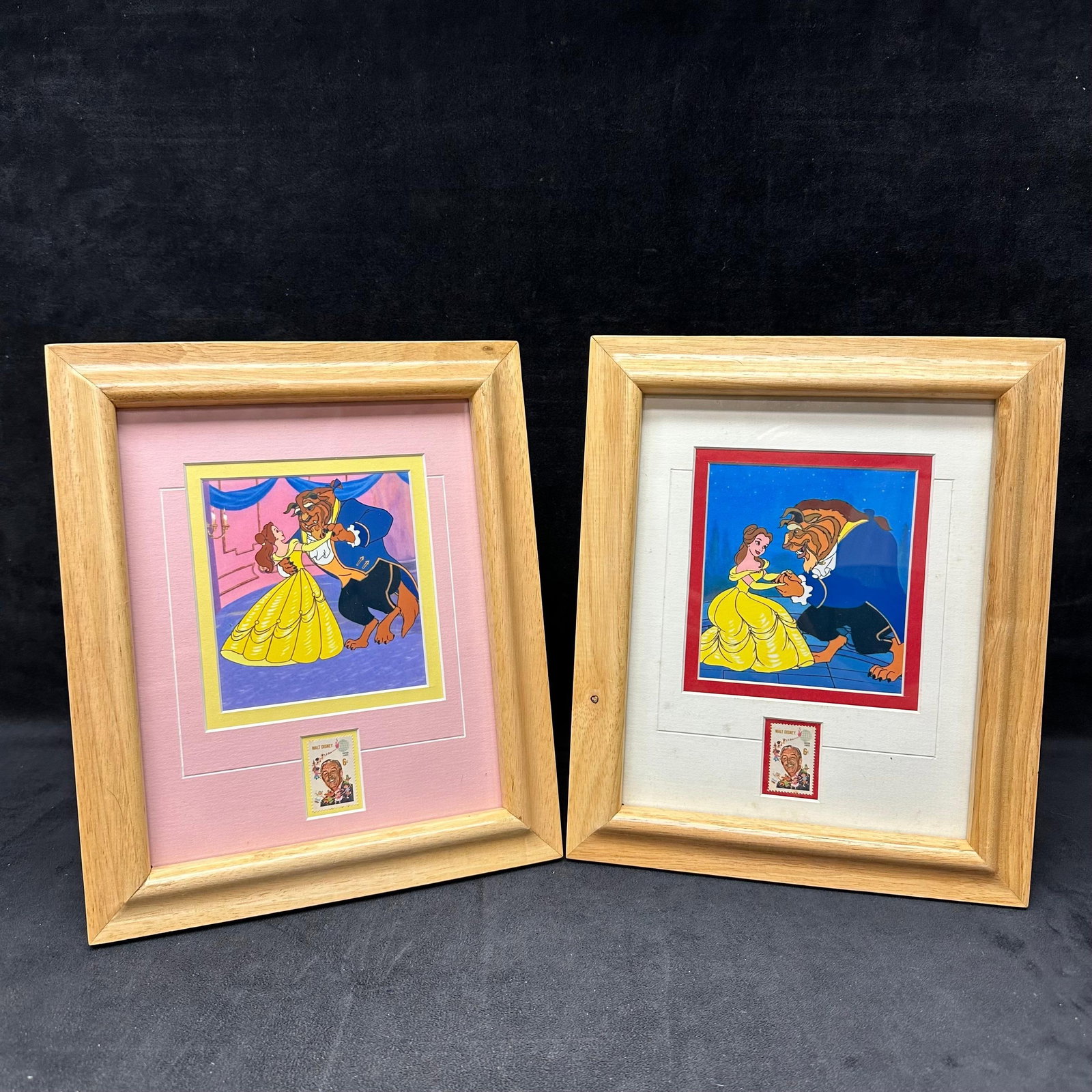 Pair of Framed Disney Beauty and the Beast Prints with Walt Disney Stamp Framed: Pair of framed Disney “Beauty & the Beast” art prints, each featuring Belle and Beast dancing. Both prints include a mounted Walt Disney postage stamp beneath the artwork. Natural wood
