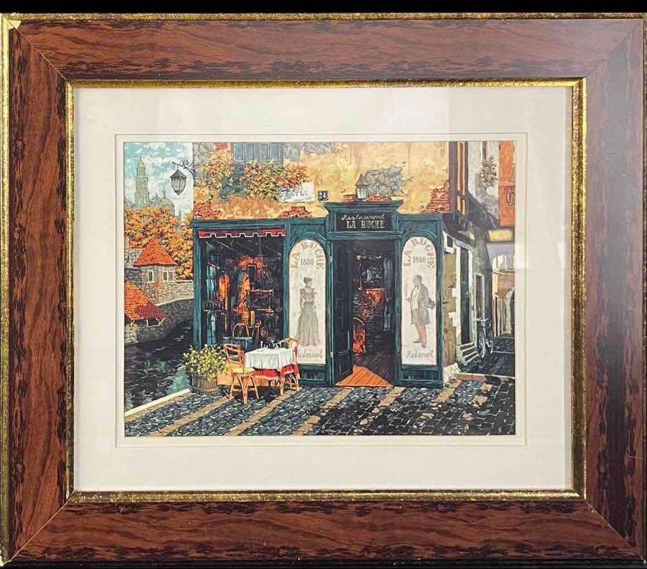 French Café Framed Art Print: French Café Framed Art Print This is a framed print of the outside of a French Cafe. This decorative piece is in good condition with slight wear on the corners of the frame. Not signed. Overall t