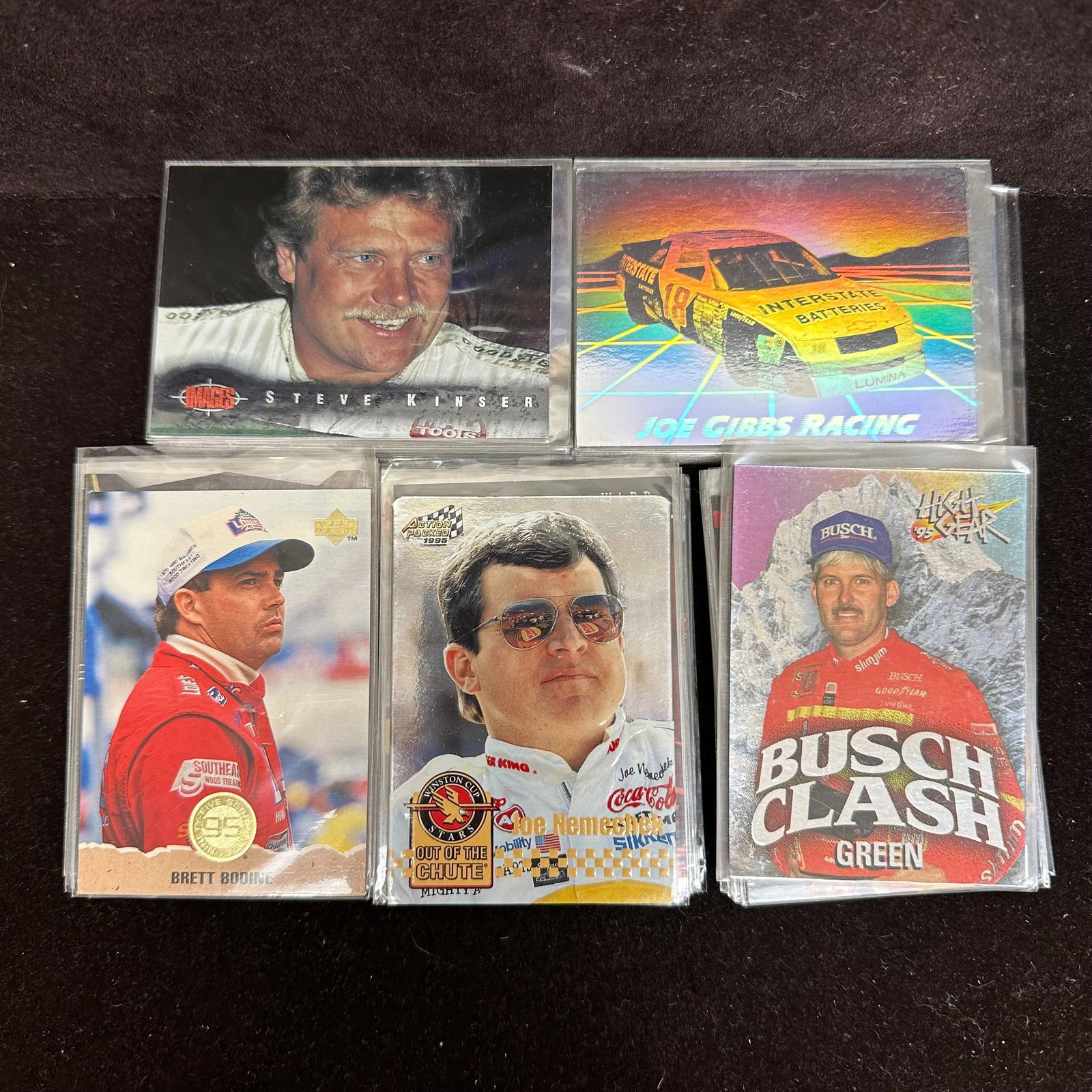 Lot of 100 NASCAR Racing Trading Cards Brett Bodine Joe Nemechek Steve Kinser and More: A group of NASCAR racing trading cards featuring drivers and racing personalities, including Brett Bodine, Joe Nemechek, Steve Kinser, Bobby Allison, Kyle Petty, and others. Cards appear from various